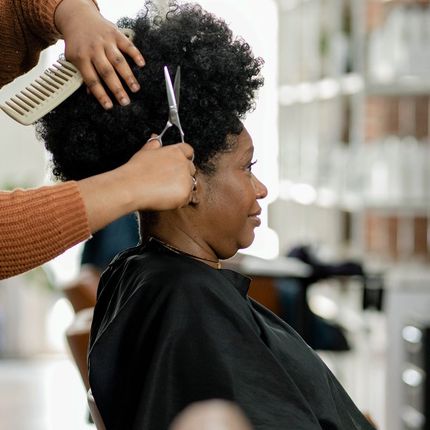 Hairstylist Trimming Customer's Hair