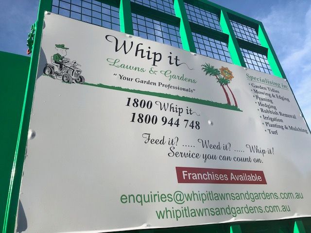 A sign for whip it lawn and garden