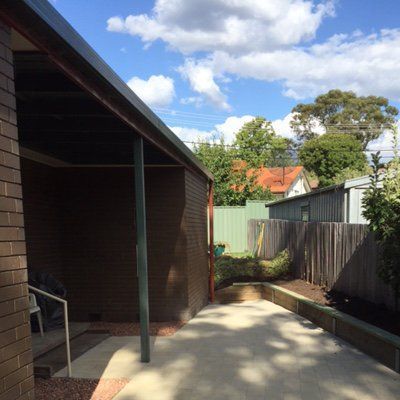 A brick building with a covered walkway leading to it