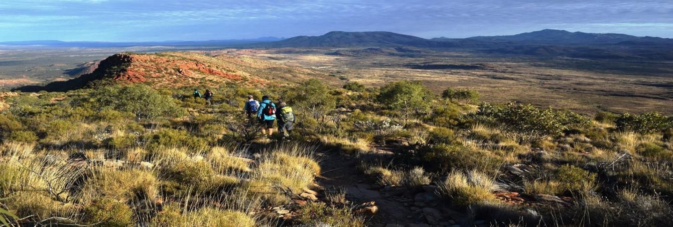Hikers on a Trail Through a Desert Landscape — Alice Springs Podiatry in Ciccone, NT
