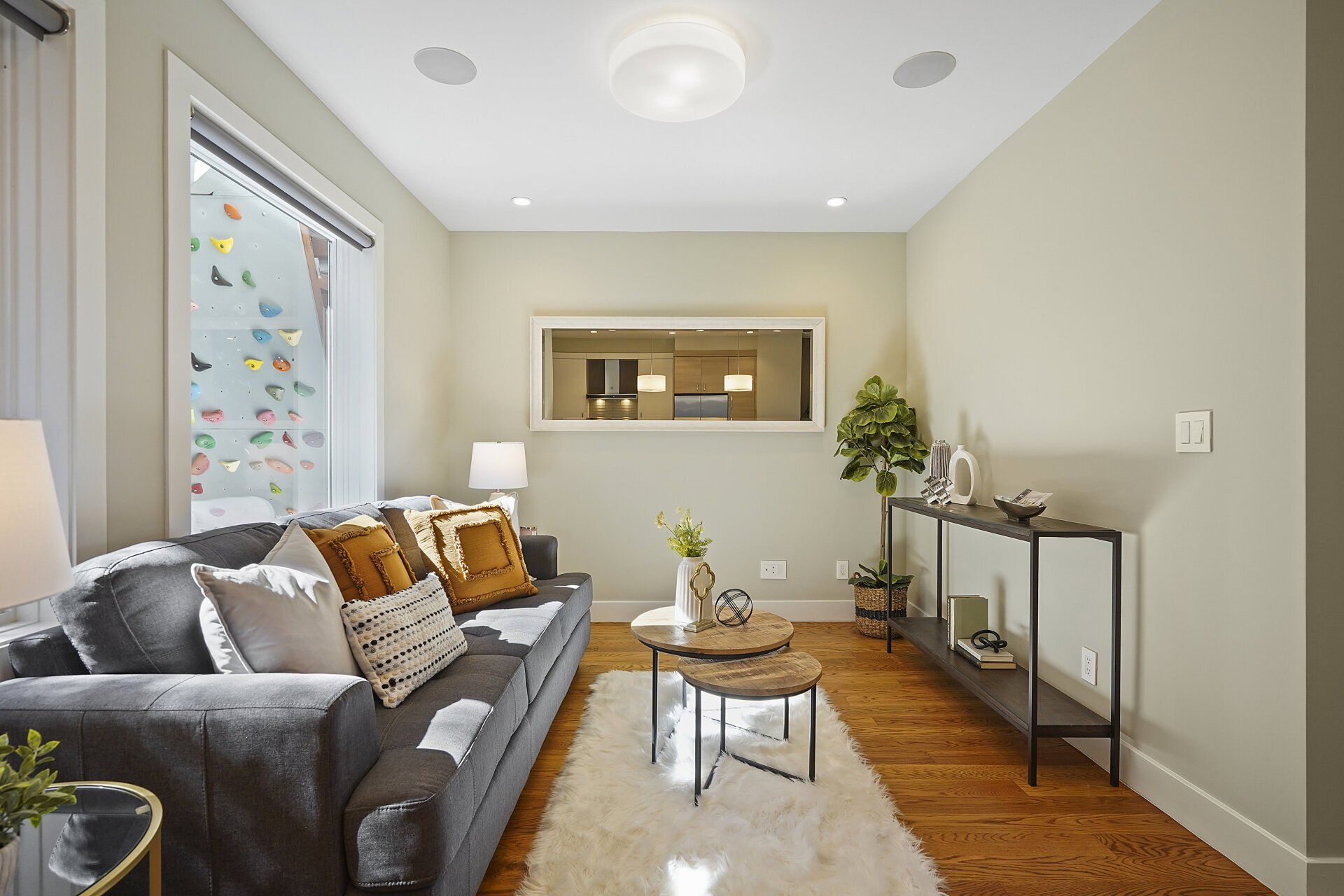A living room with a couch and two small coffee tables.