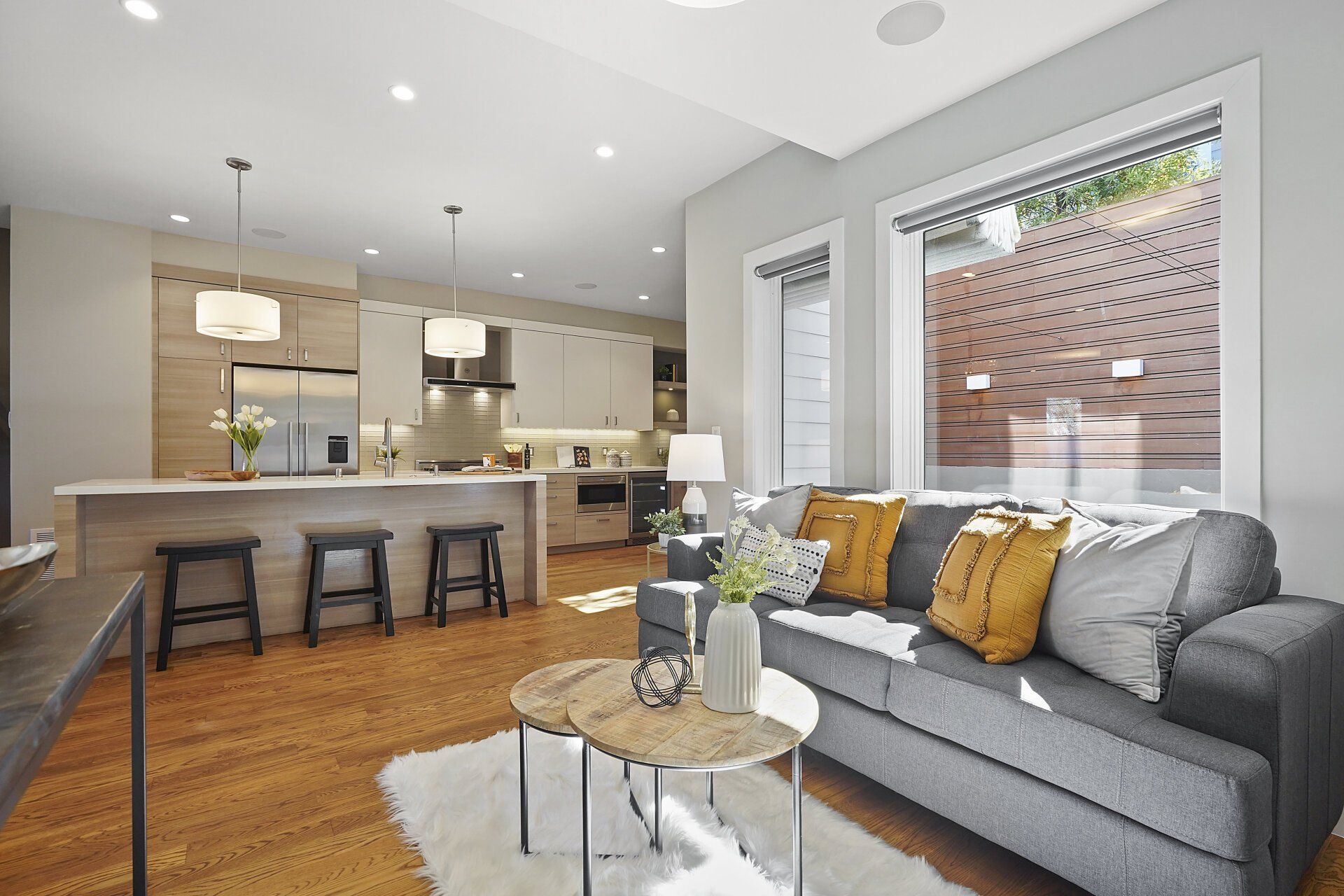 A living room with a couch and two small coffee tables.