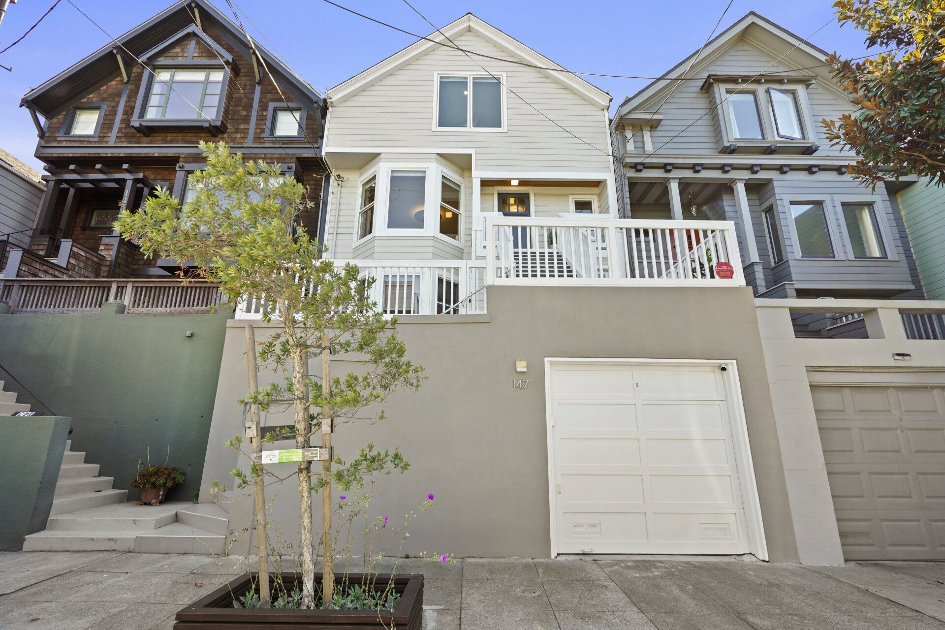 The front of a house with a white garage door.