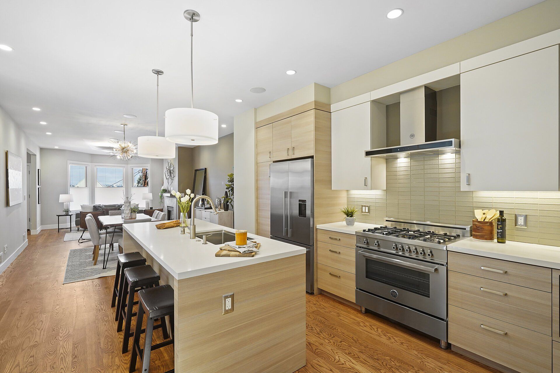 A kitchen with stainless steel appliances and wooden cabinets.