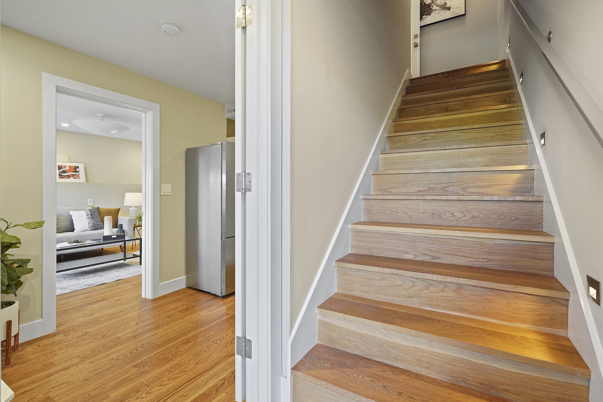 A wooden staircase leading up to the second floor of a house.