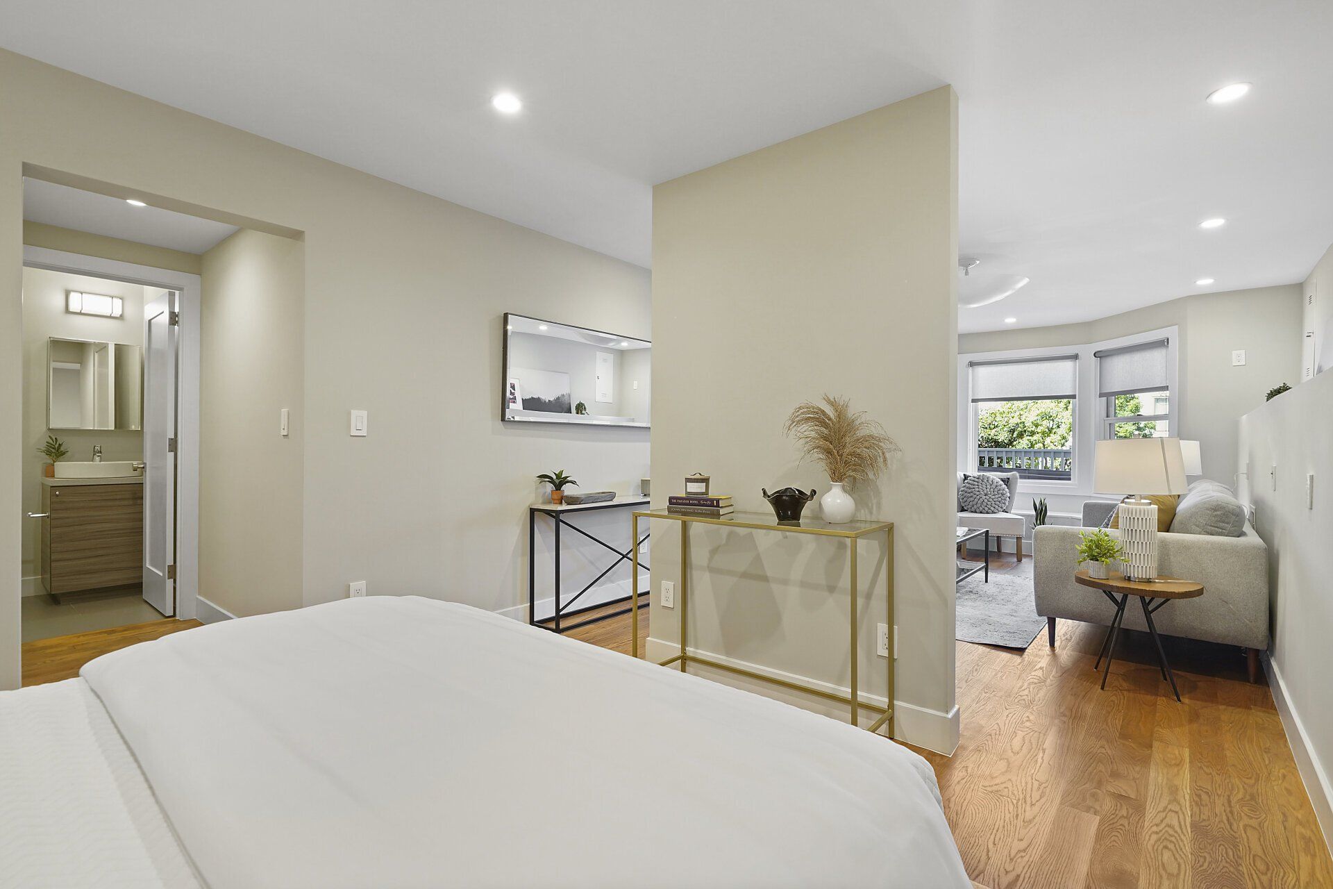 A bedroom with a bed and a table.