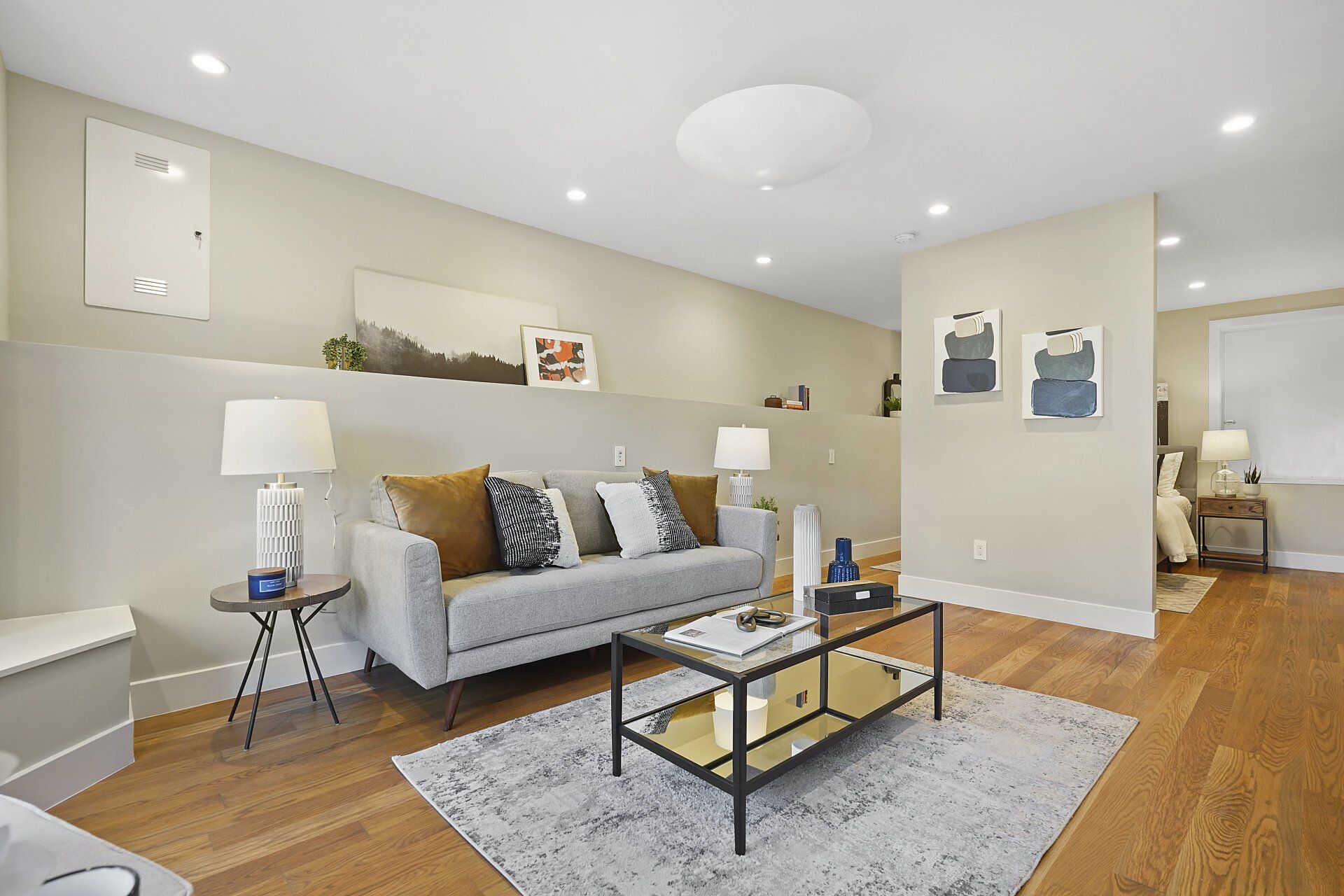 A room with a couch and a coffee table.