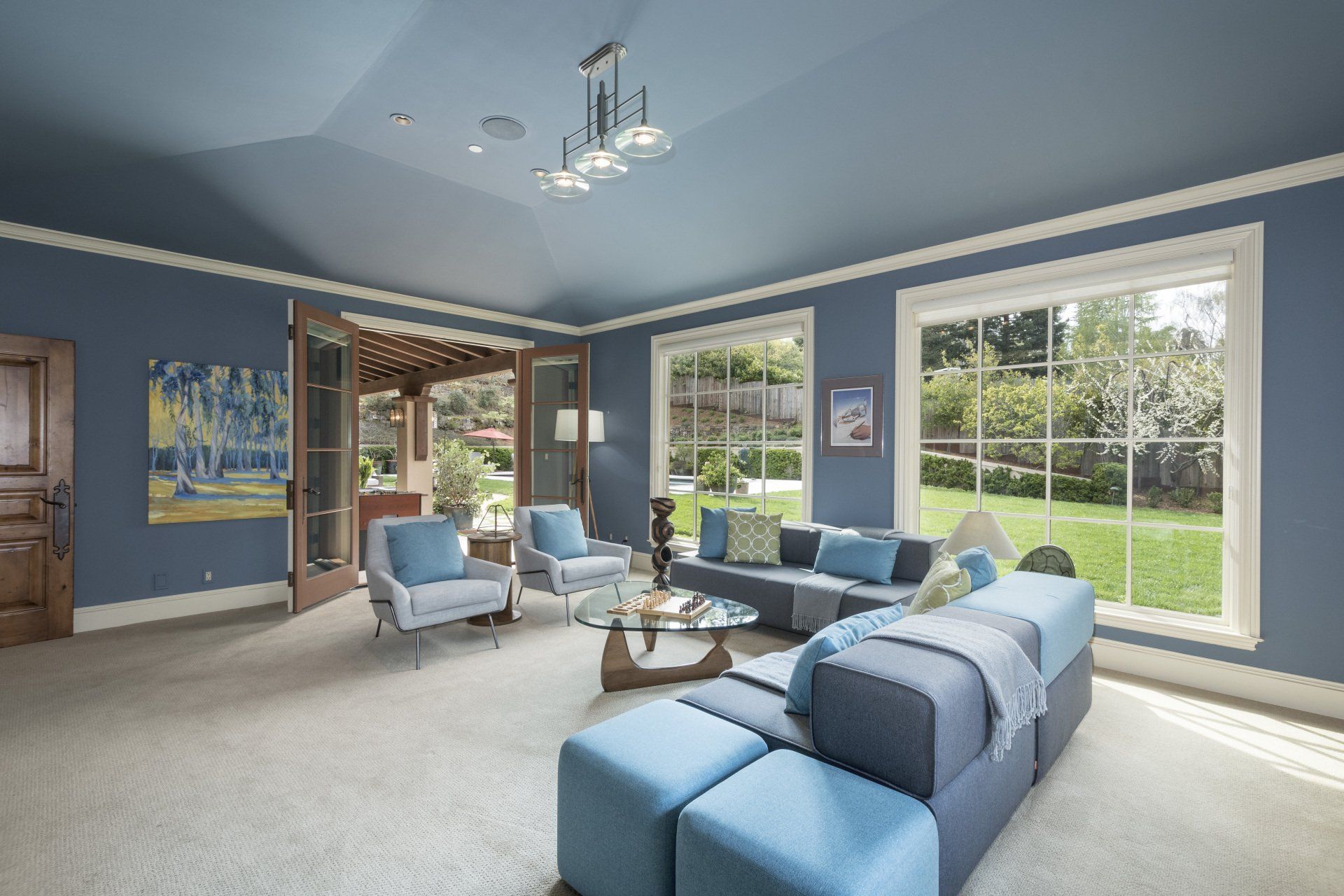 A living room with blue walls and blue furniture