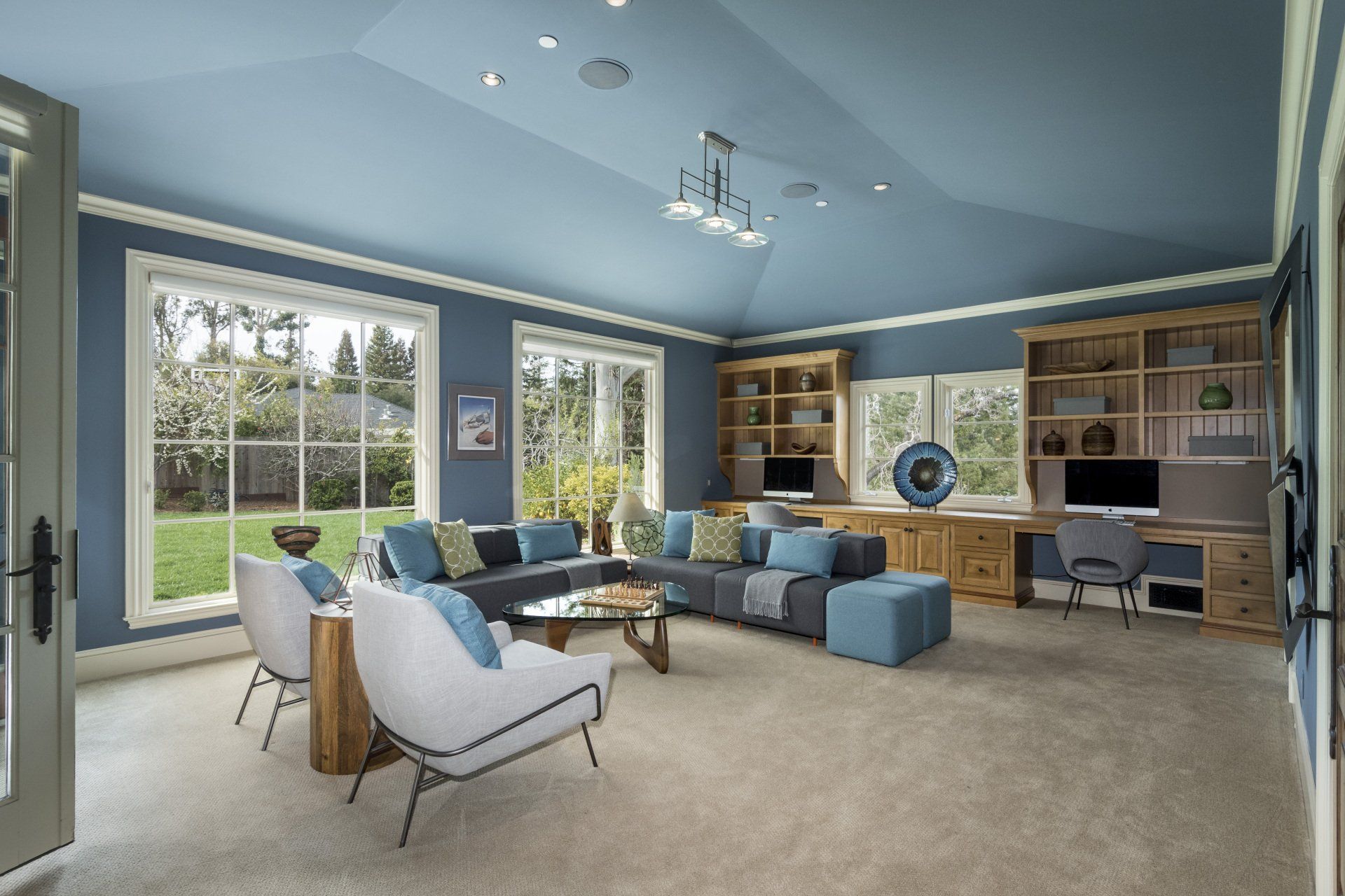 A living room with blue walls and blue furniture