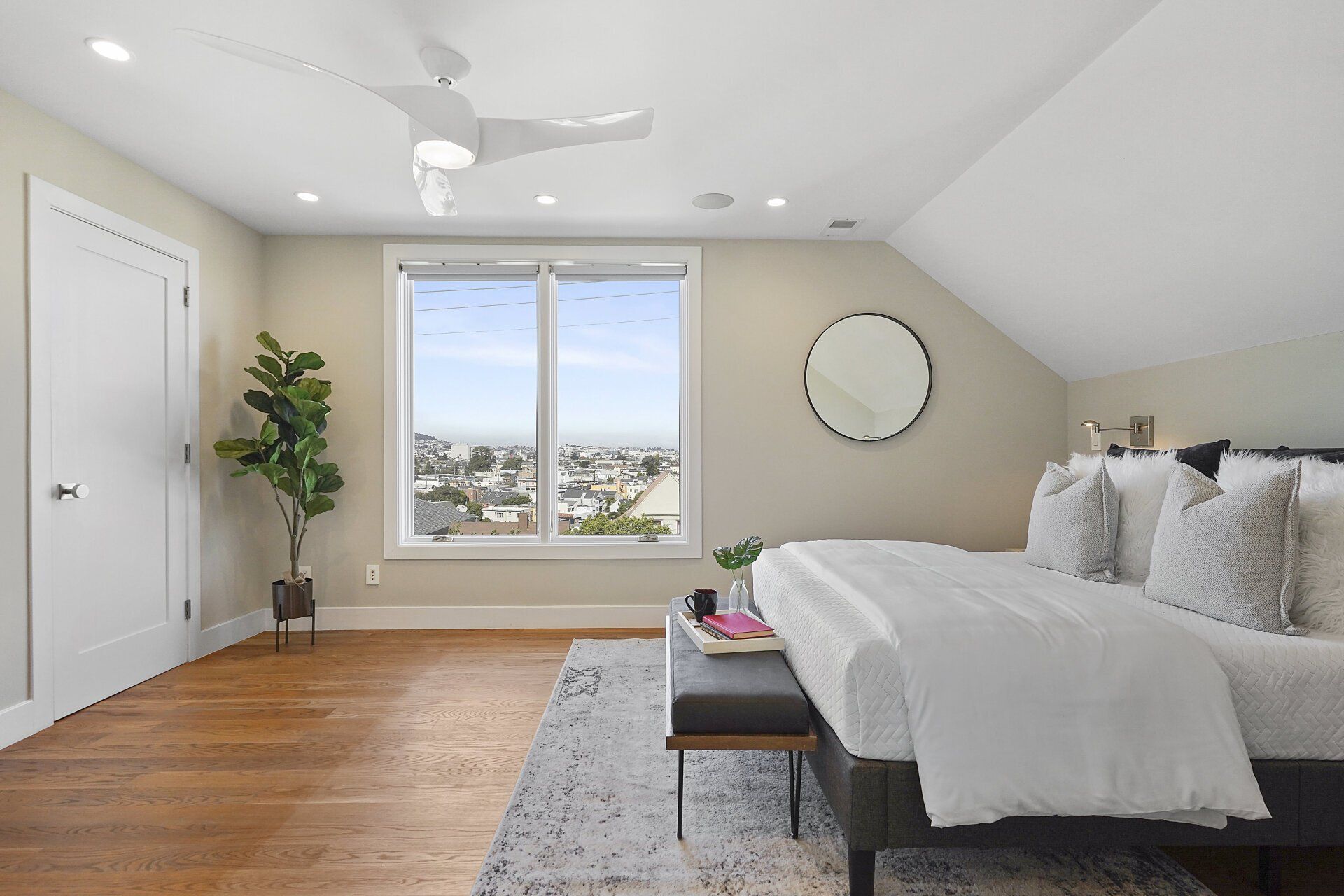 A bedroom with a bed and a ceiling fan.