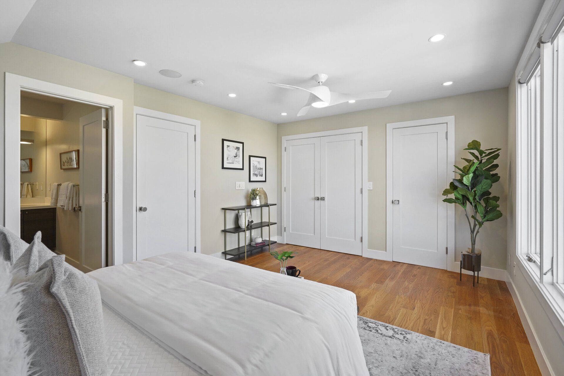 A bedroom with a bed and a ceiling fan.