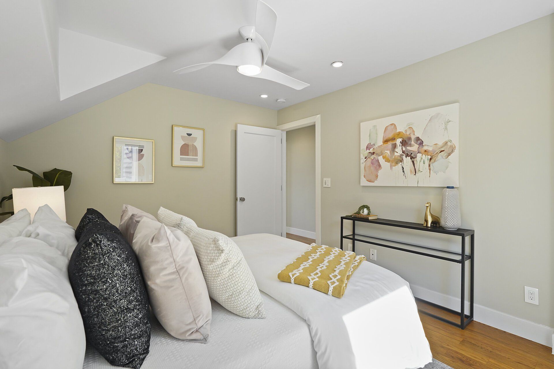 A bedroom with a  bed and a ceiling fan.