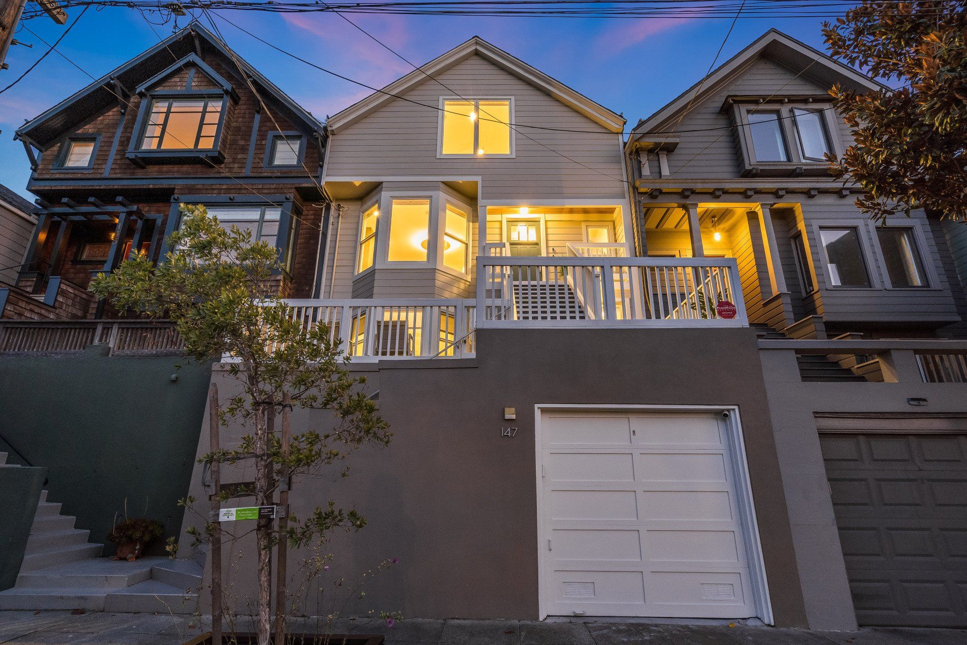 A row of houses are lined up next to each other on a hill.