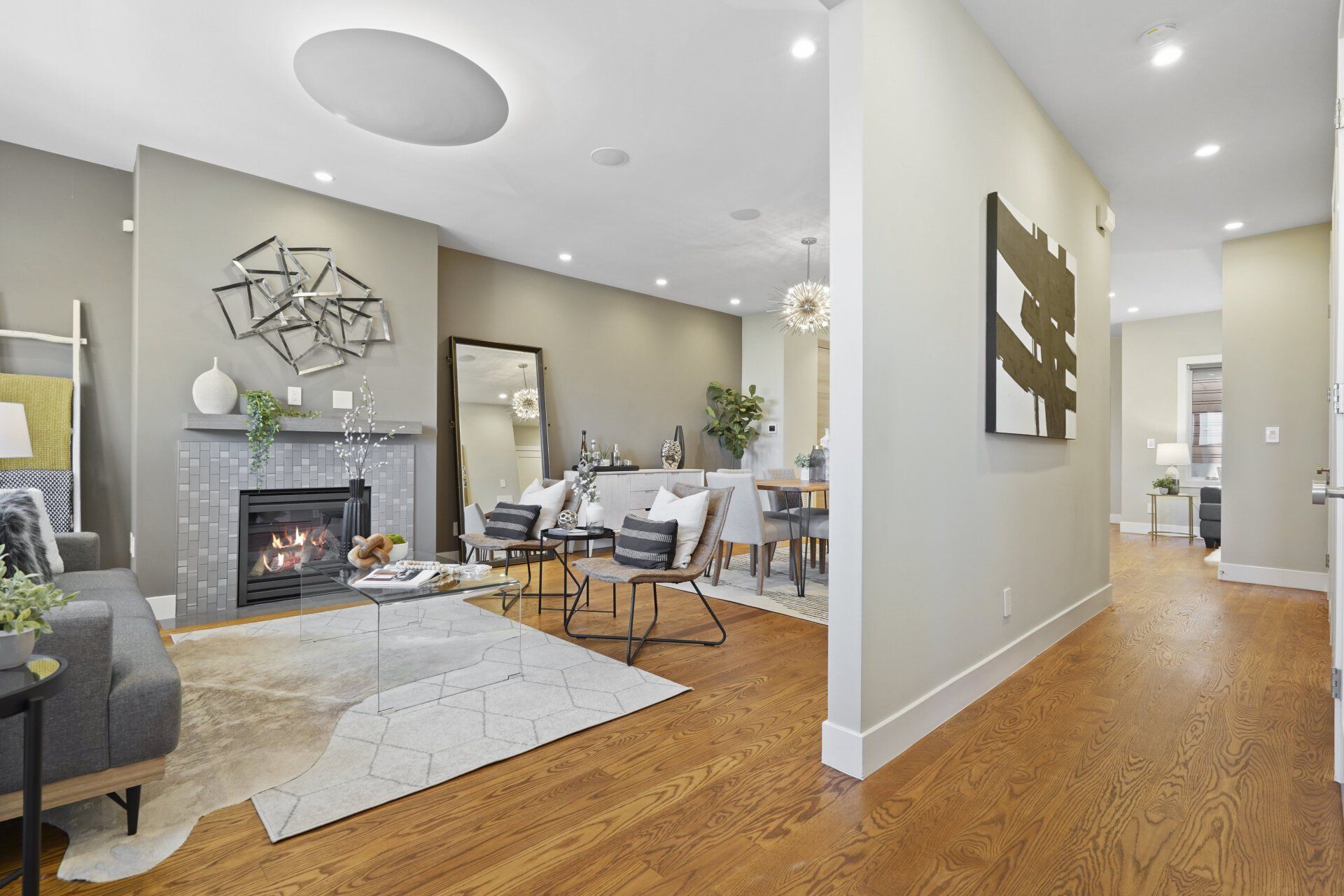 A living room with hardwood floors and a fireplace.