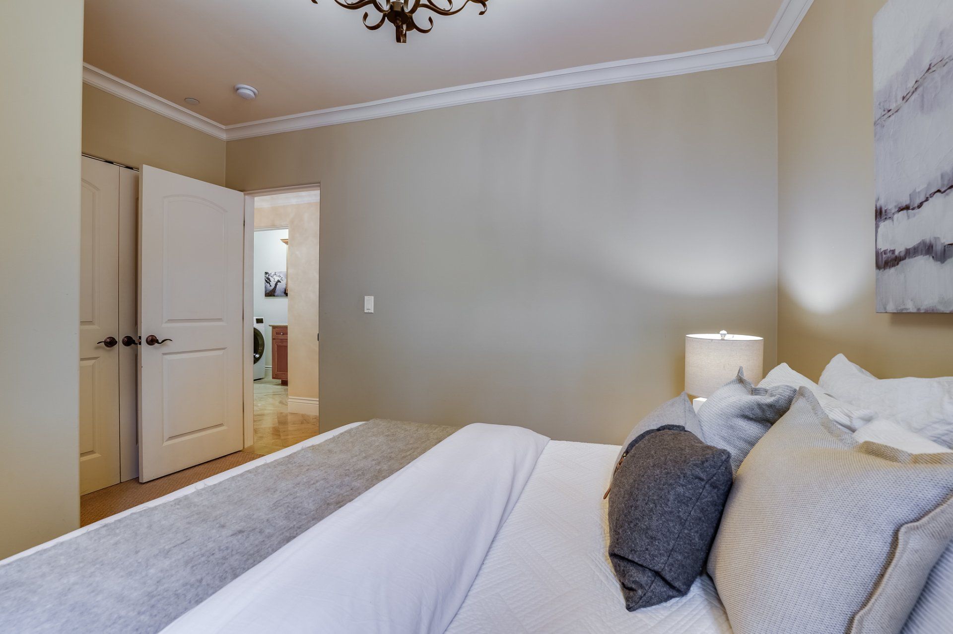 A bedroom with a bed and a lamp