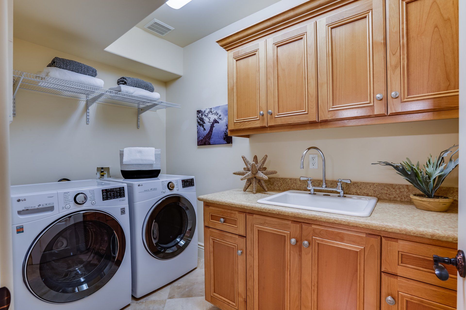 A laundry room with a washer and dryer and a sink.
