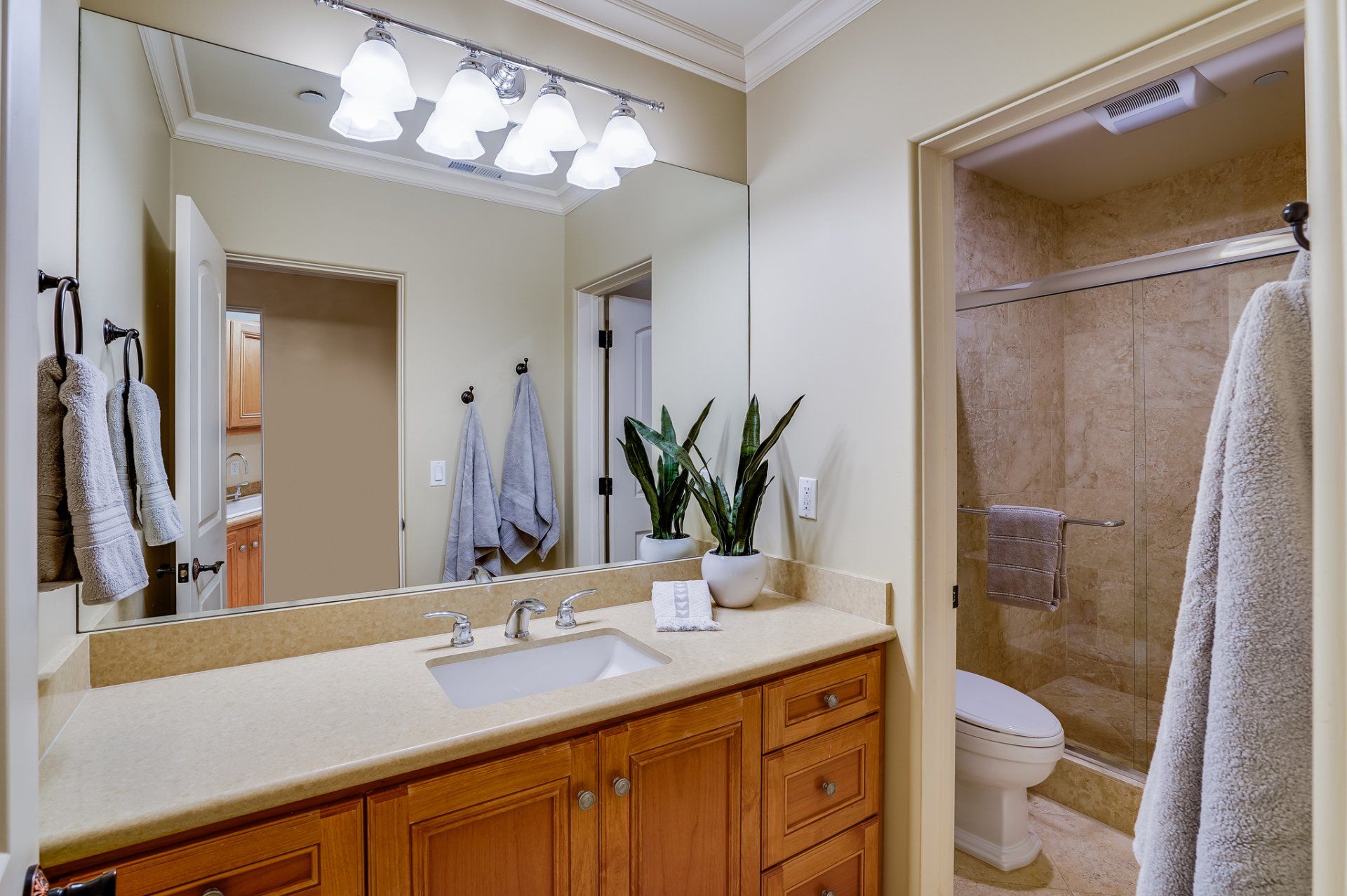 A bathroom with a sink , toilet , and mirror.