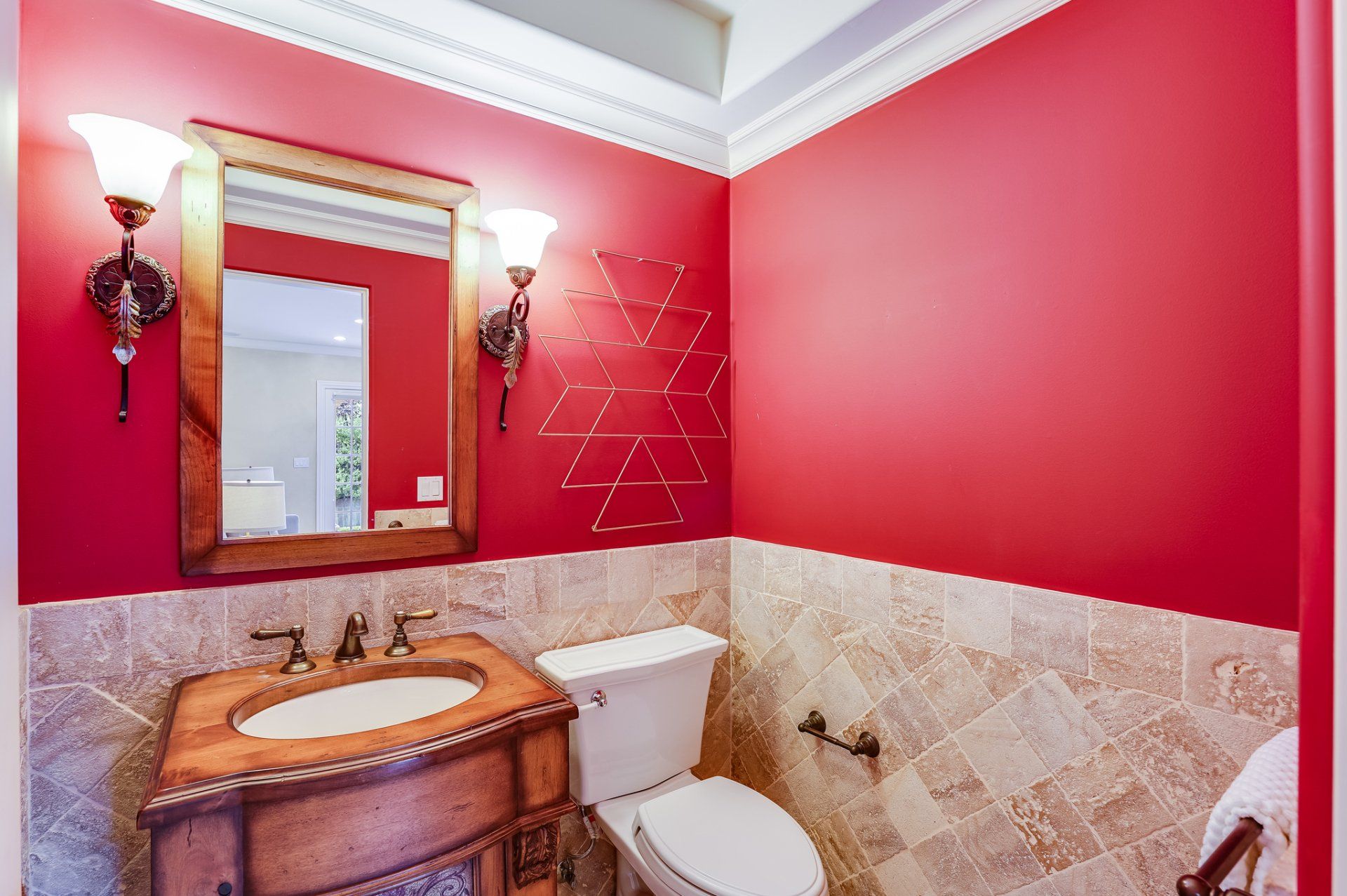 A bathroom with red walls and a sink and toilet