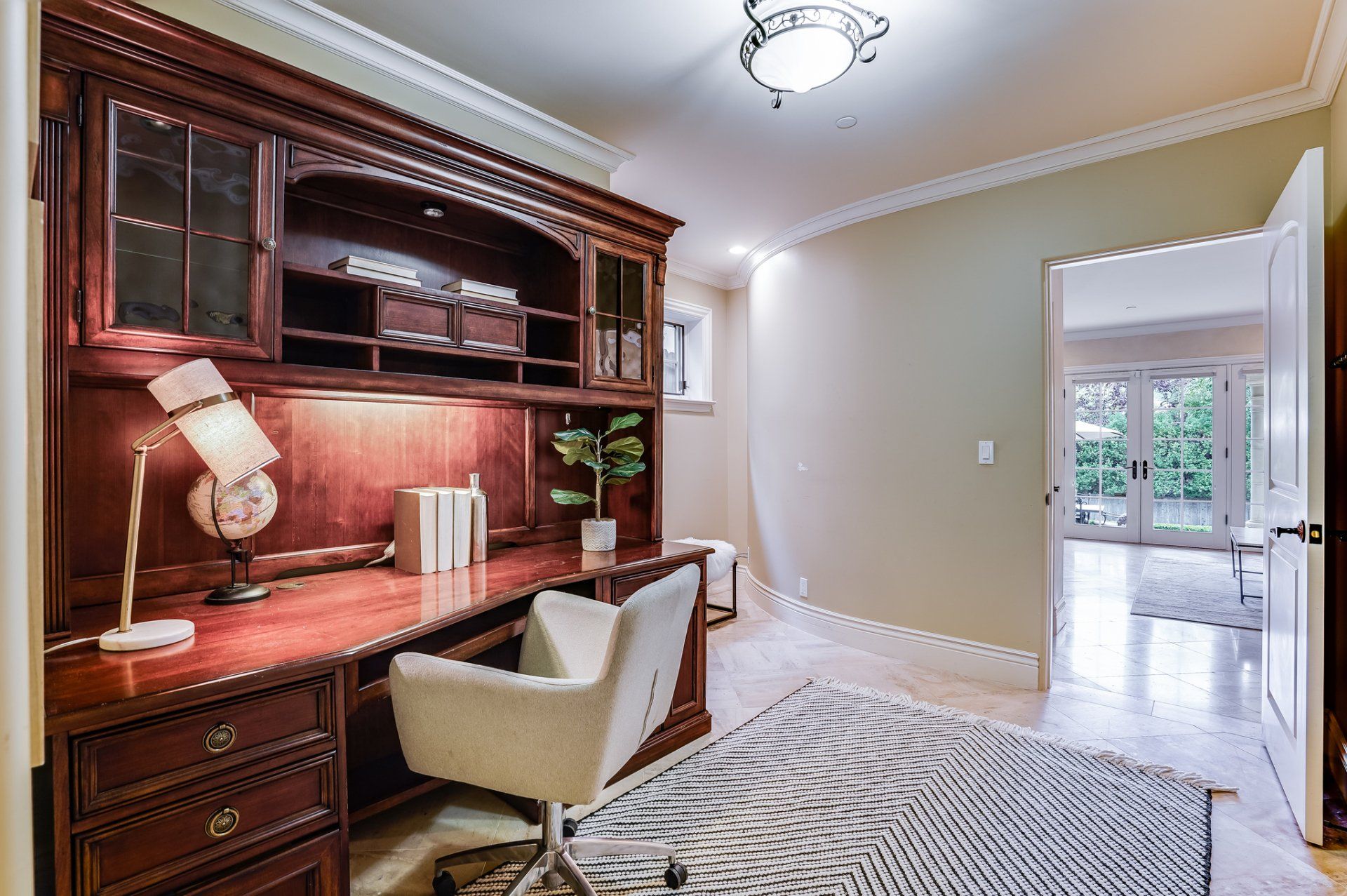 A home office with a wooden desk and chair