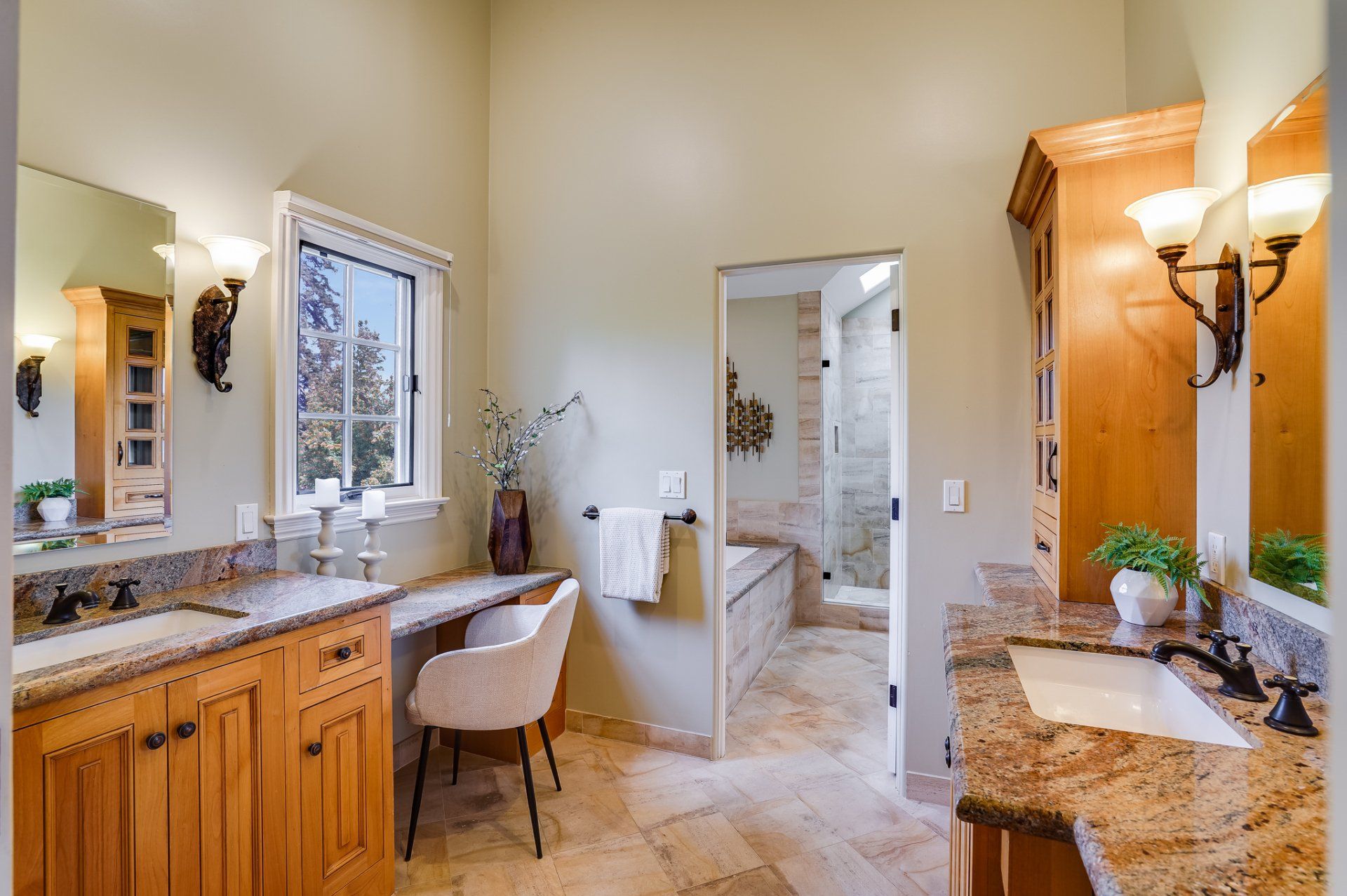 A bathroom with two sinks and a chair in it