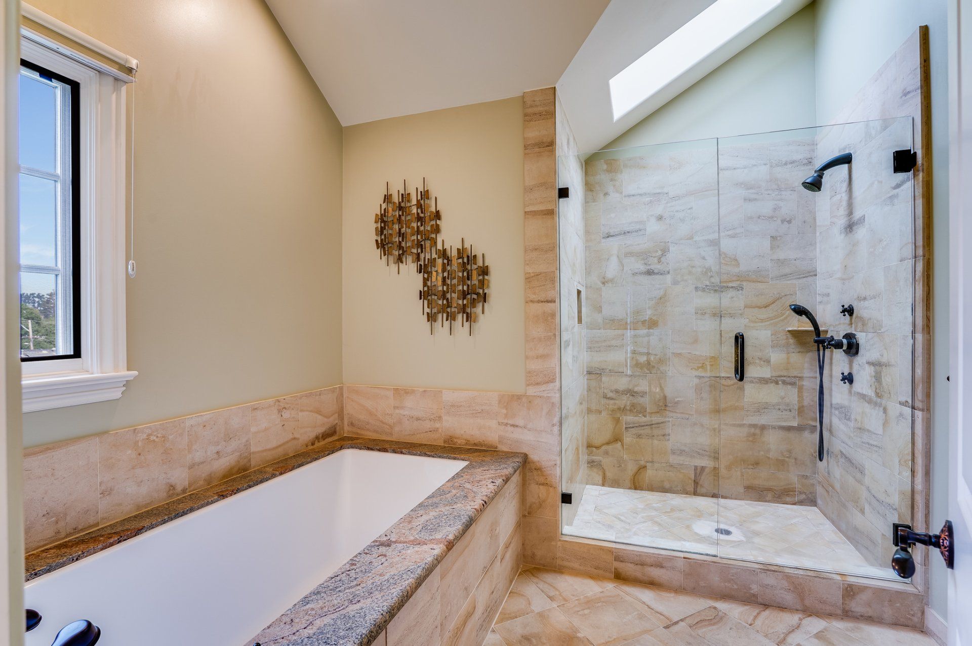 A bathroom with a tub and a walk in shower.