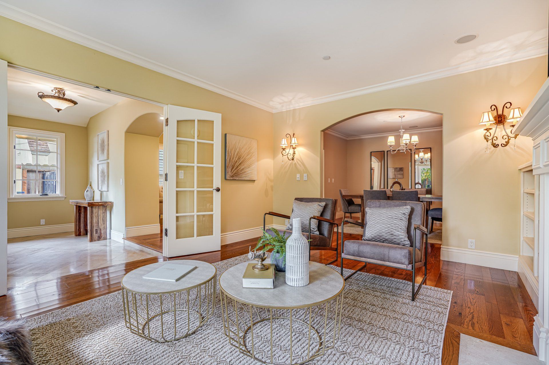 A living room with a round coffee table and chairs