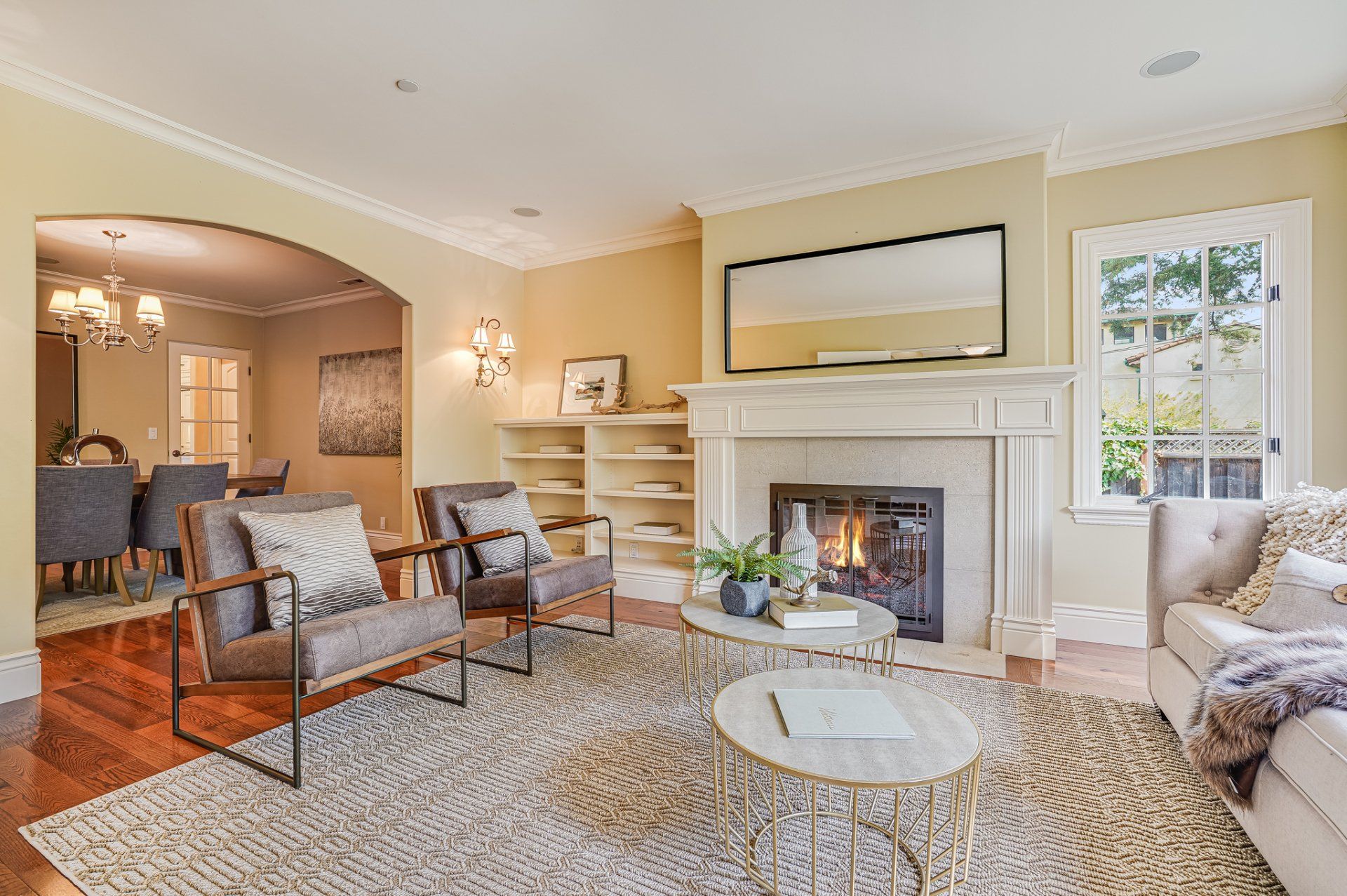 A living room with a fireplace , couch , chairs and a coffee table.