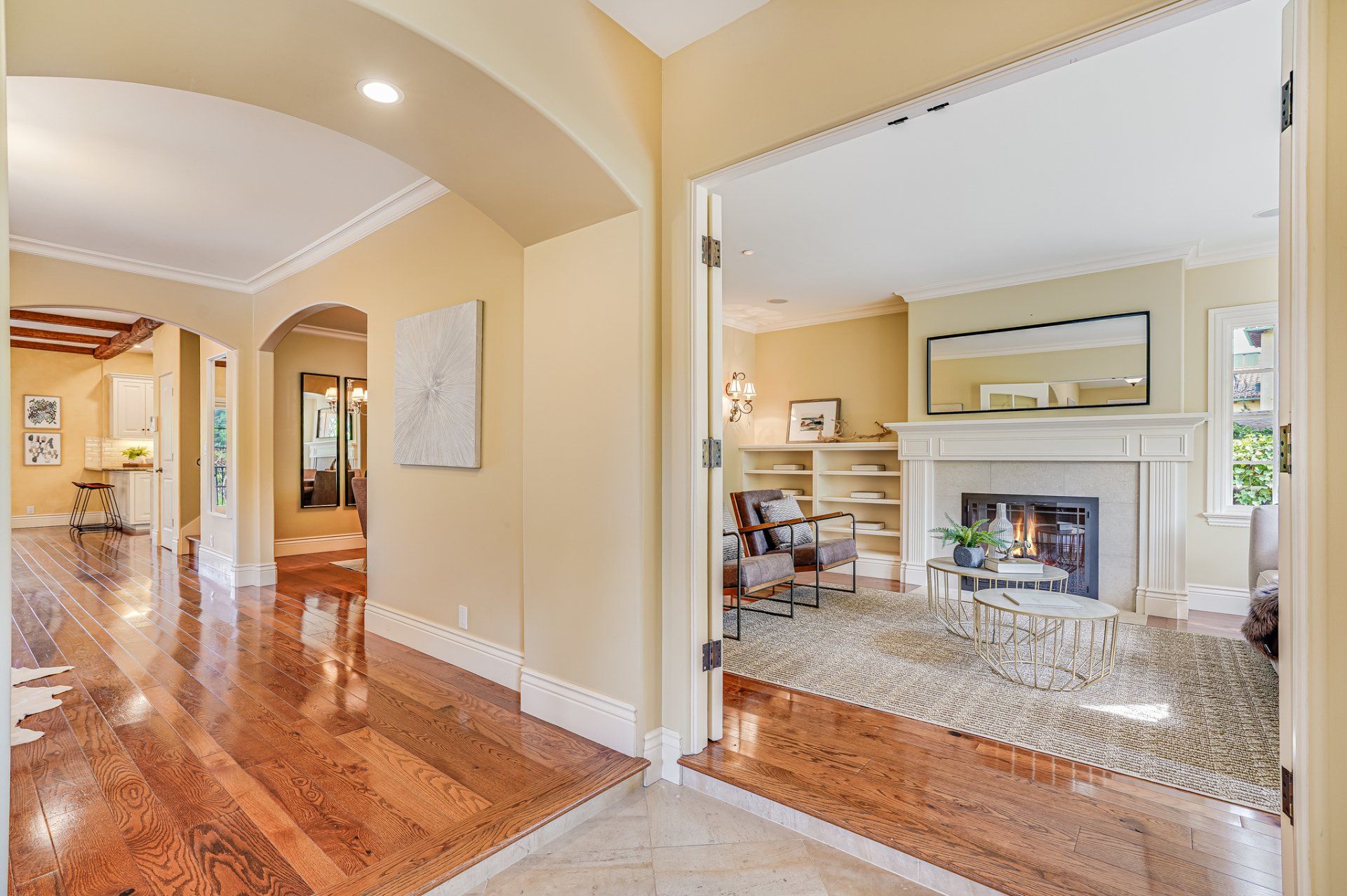 A living room with hardwood floors and a fireplace