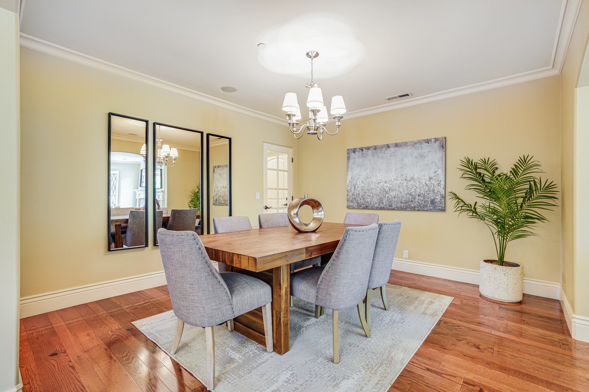 A dining room with a table and chairs and a chandelier