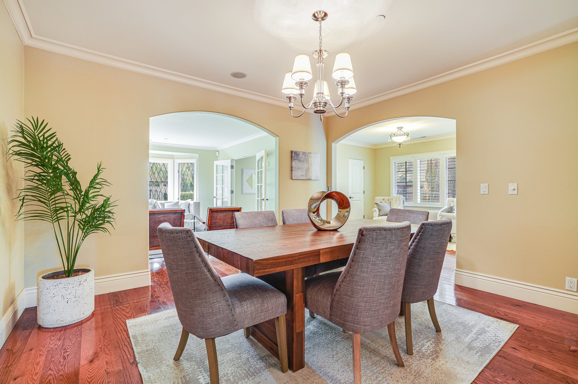 A dining room with a table and chairs and a chandelier
