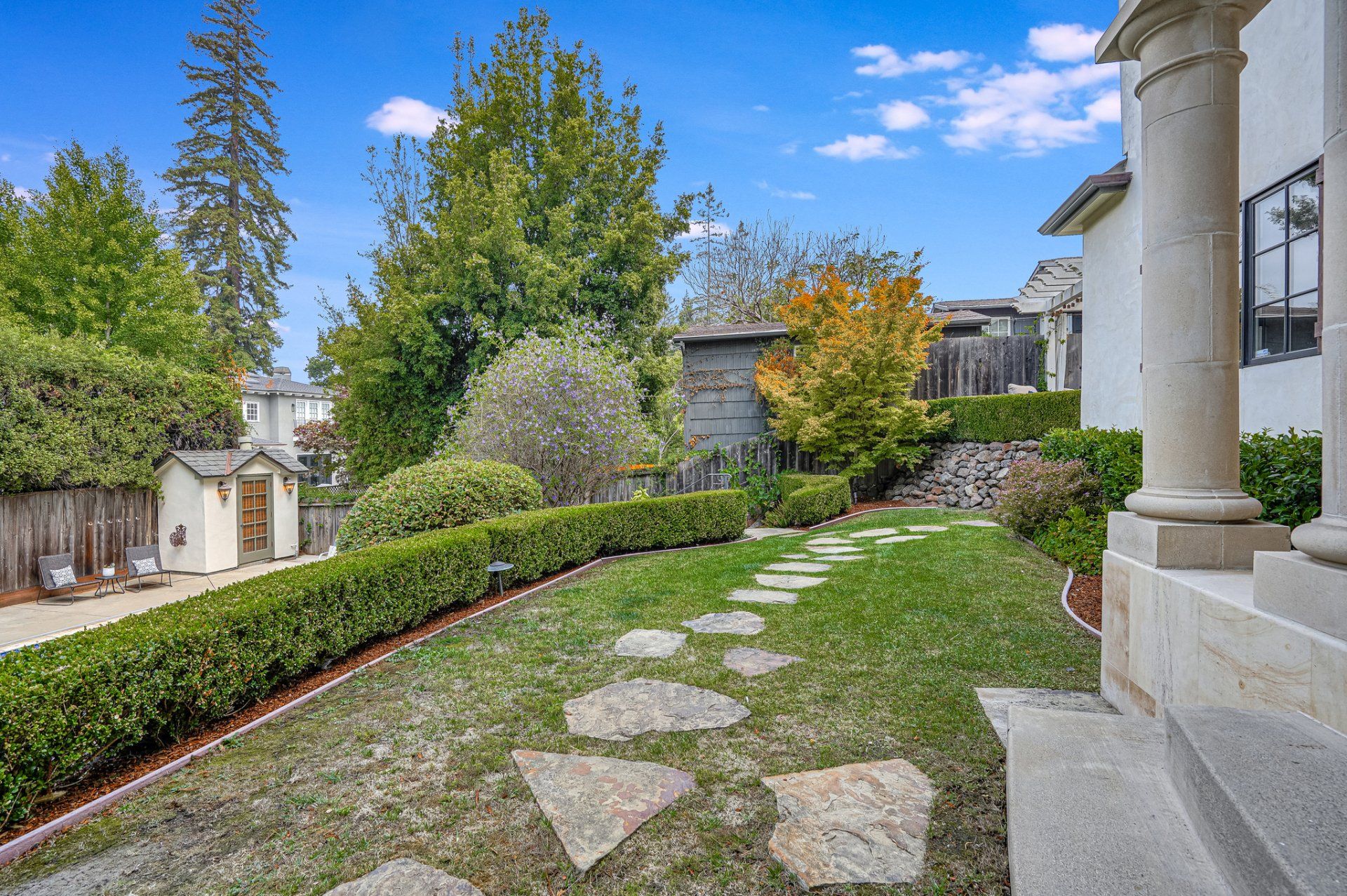There is a stone walkway leading to the the house.