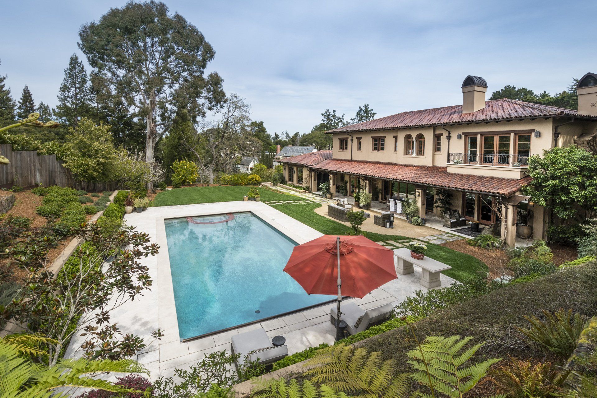 A large house with a large swimming pool in front of it
