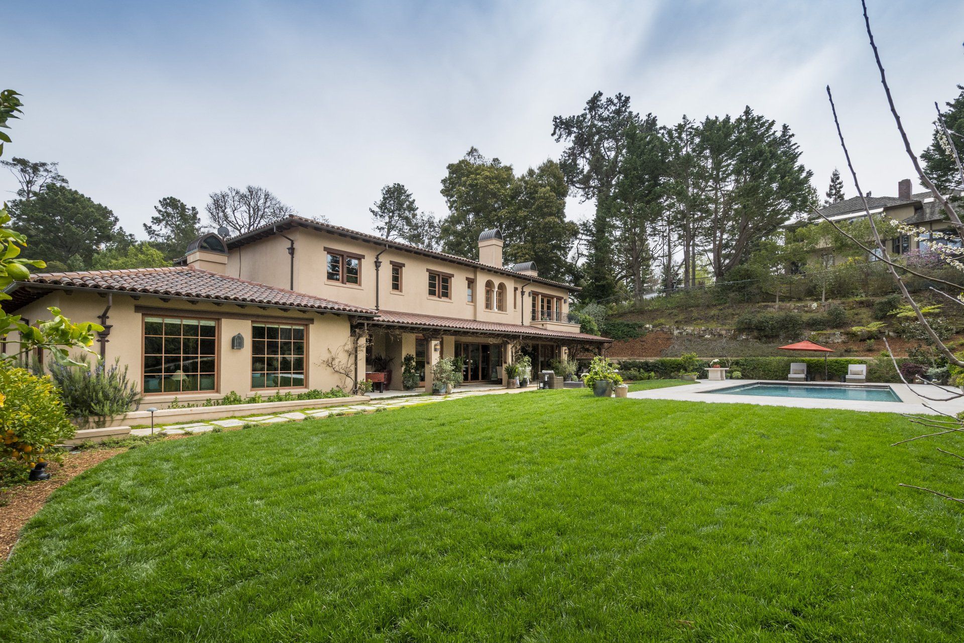 A large house with a swimming pool in the backyard
