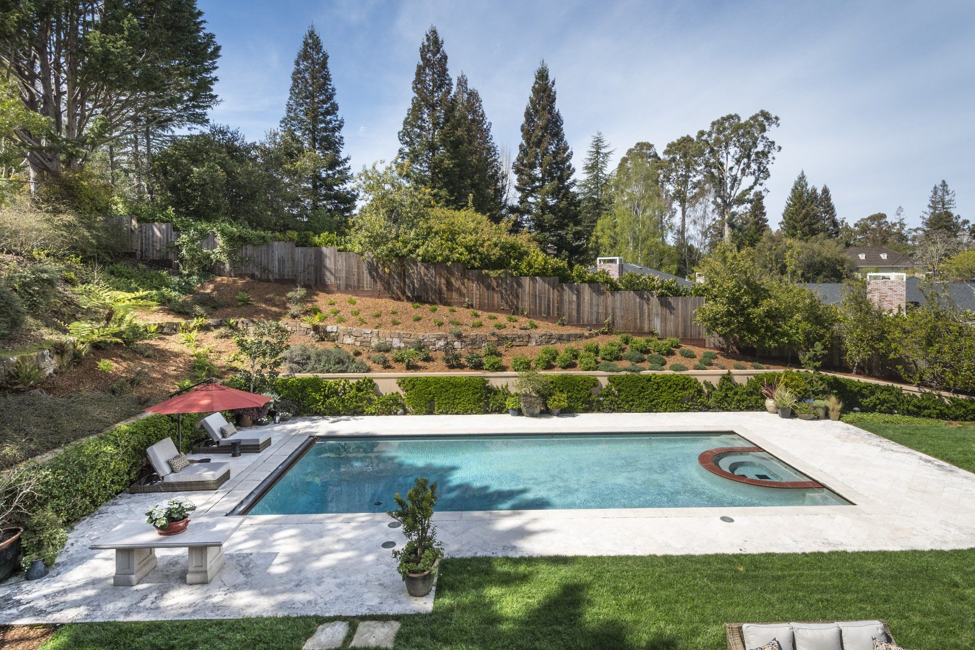 A large swimming pool in the backyard of a house