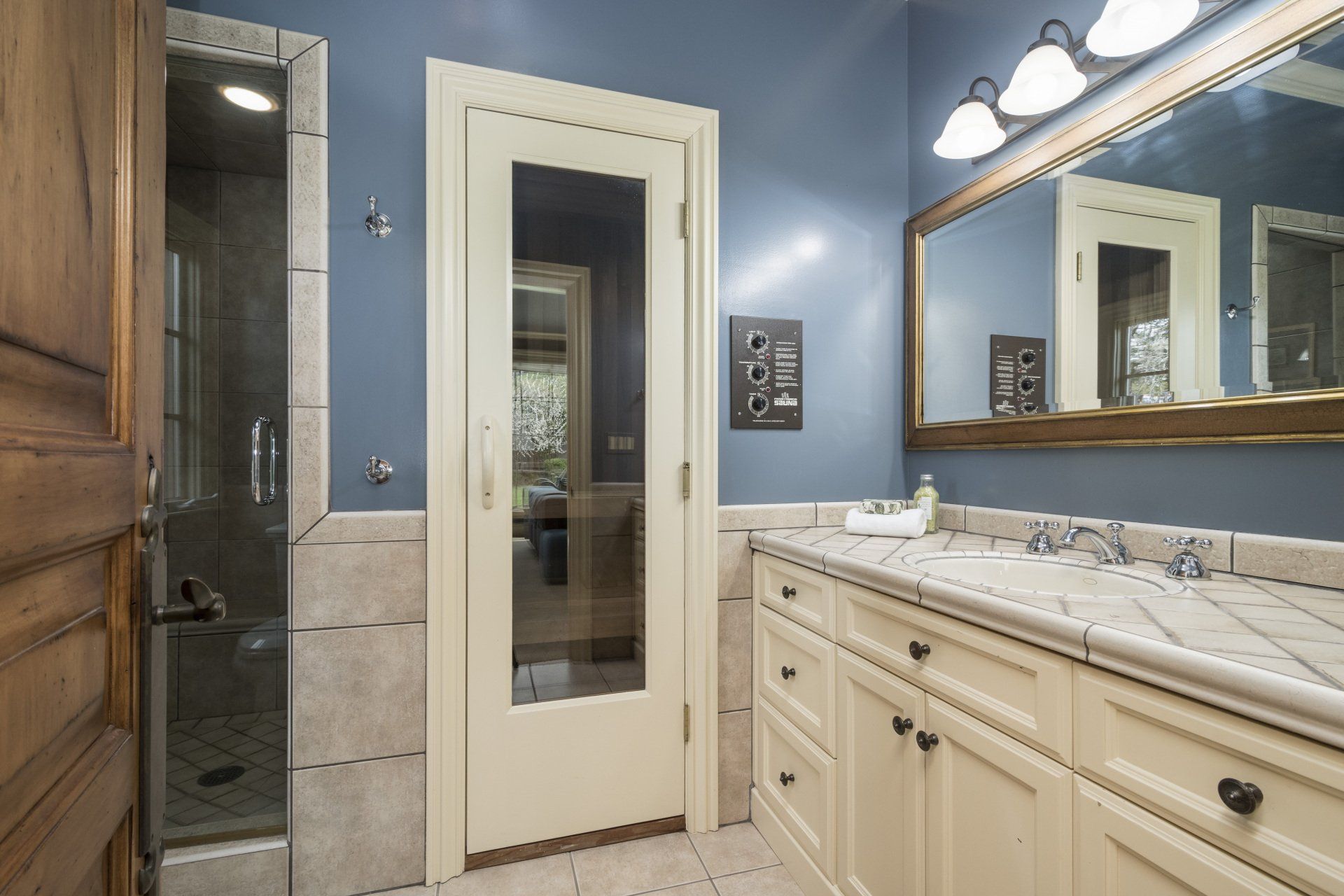 A bathroom with a sink and a large mirror