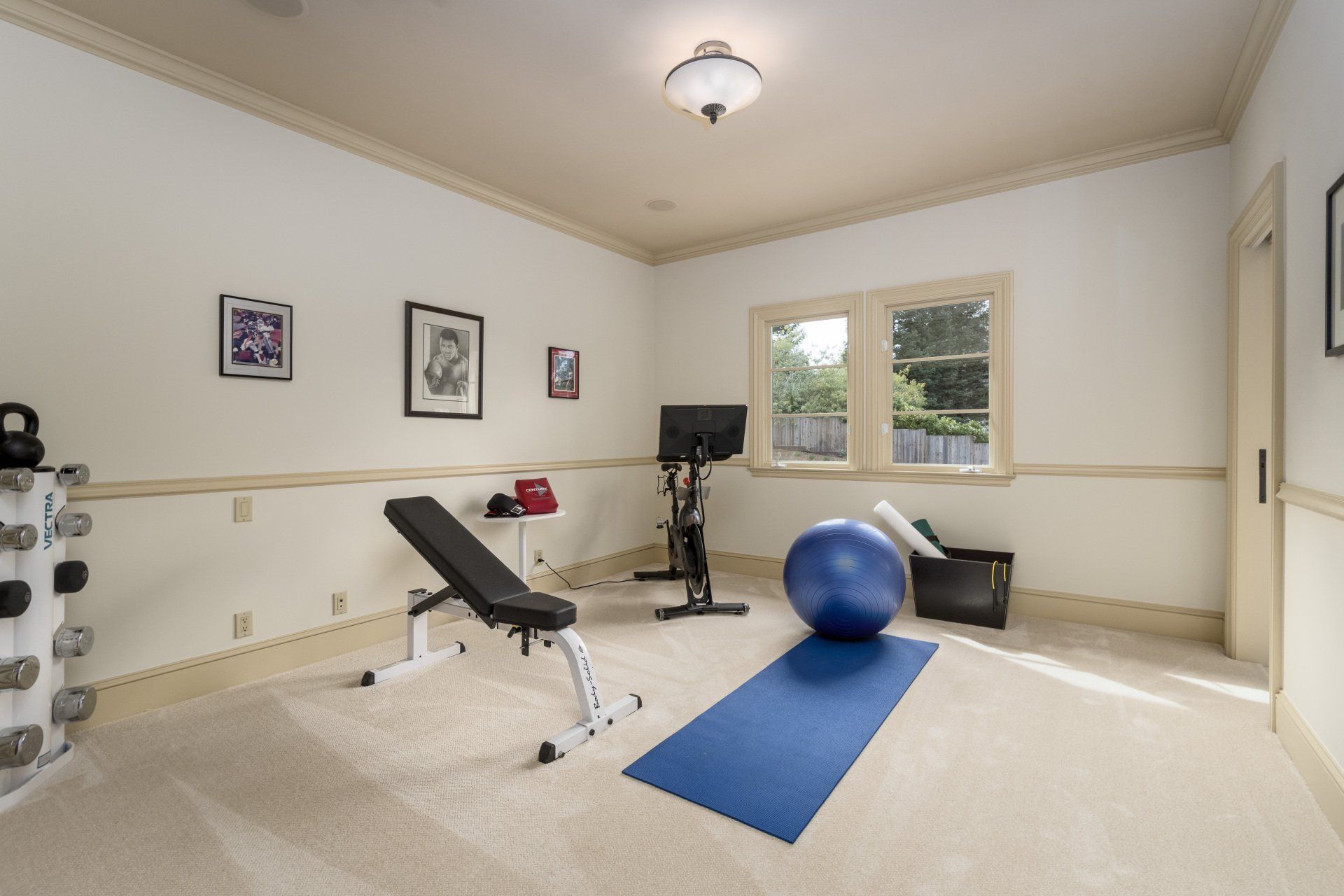 A gym with a blue mat and an exercise ball