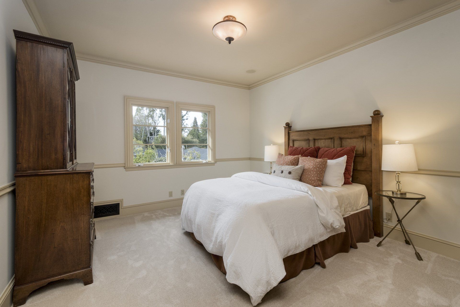 A bedroom with a bed and a dresser