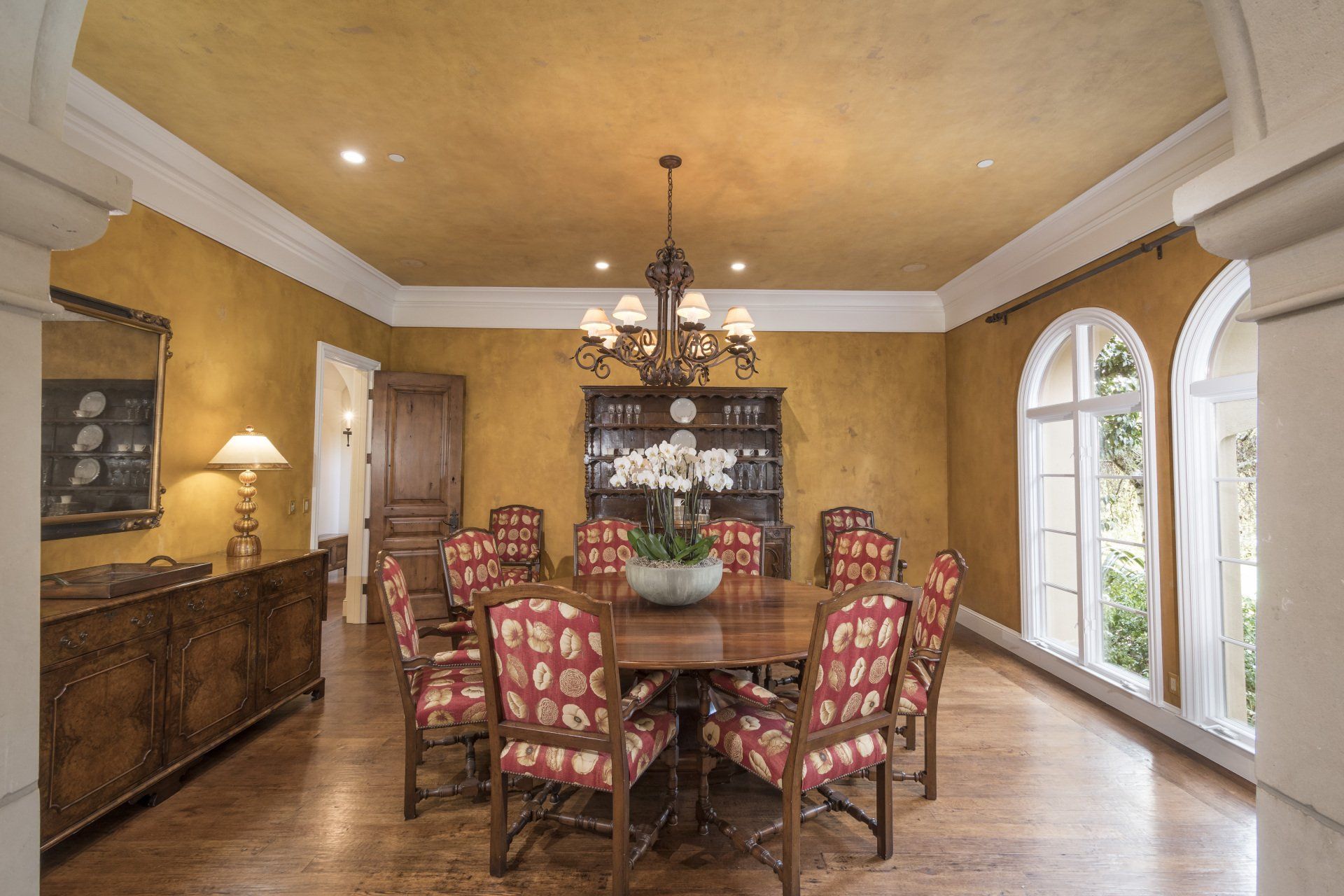 A dining room with a table and chairs and a chandelier