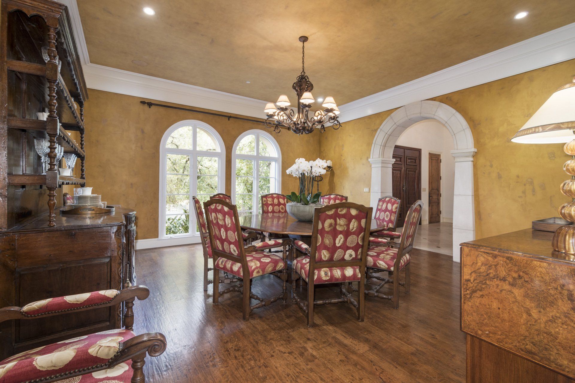 A dining room with a table and chairs and a chandelier