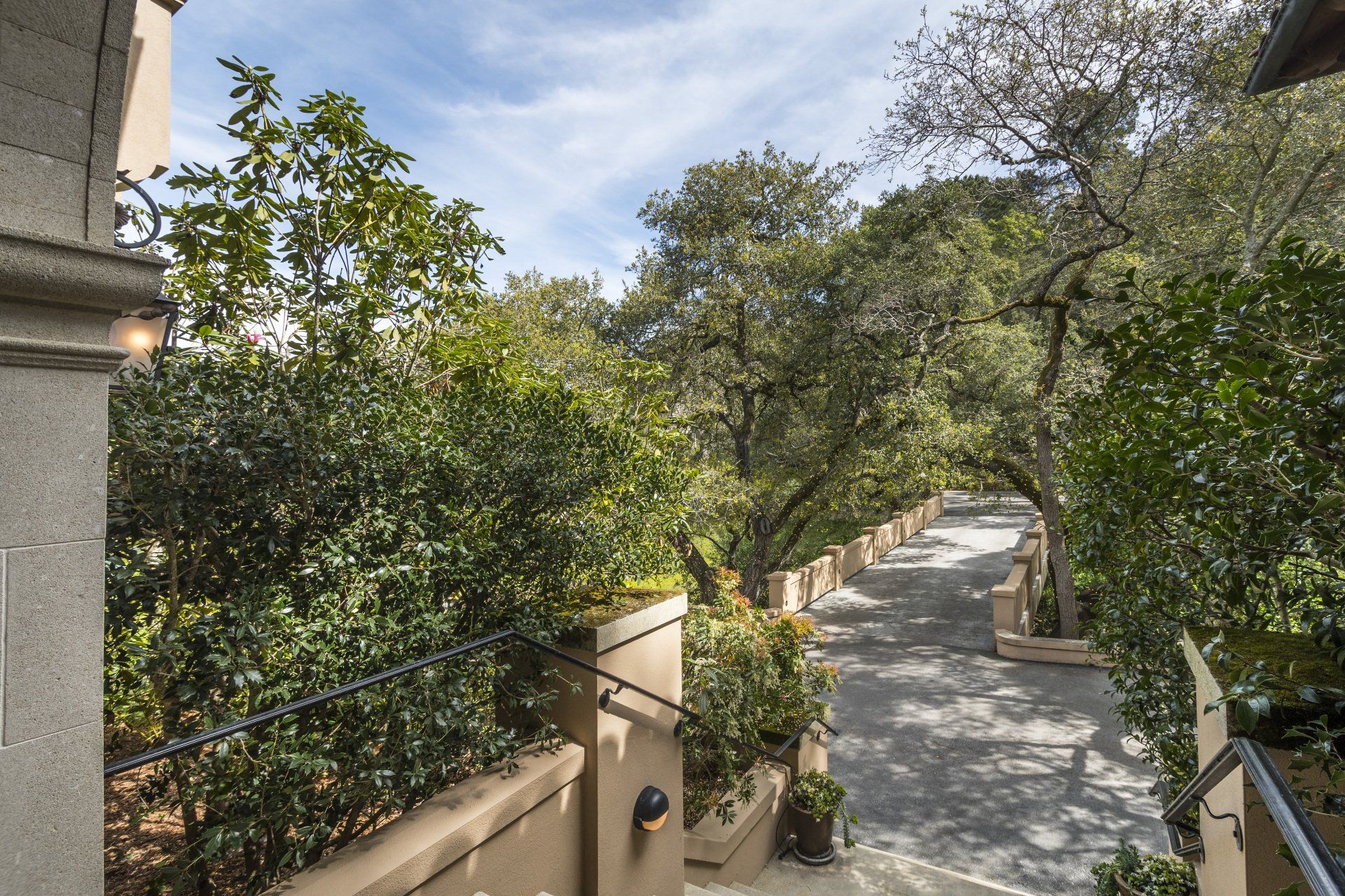 A staircase leading up to a house surrounded by trees