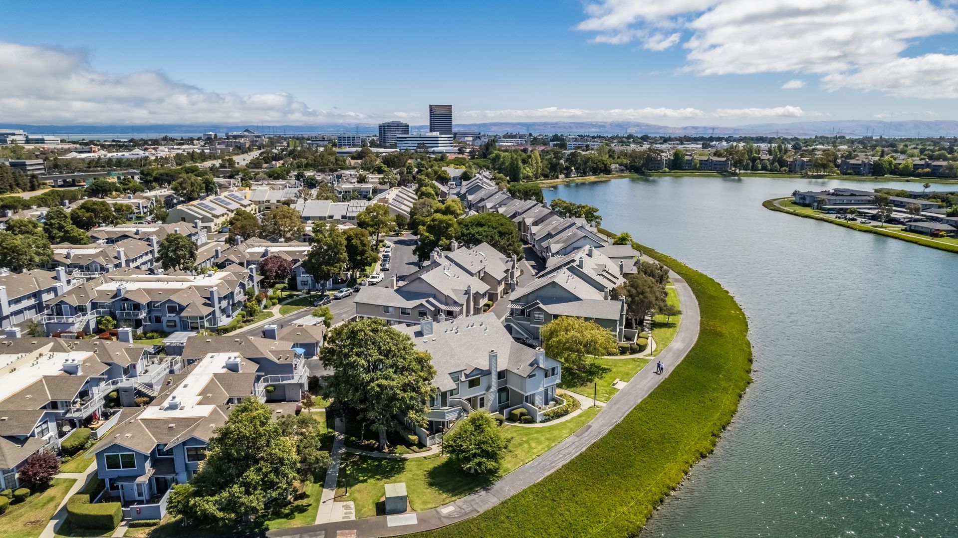 An aerial view of a residential area next to a body of water.