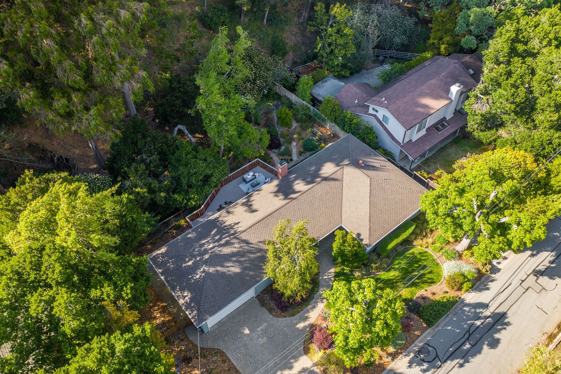 An aerial view of a house surrounded by trees.