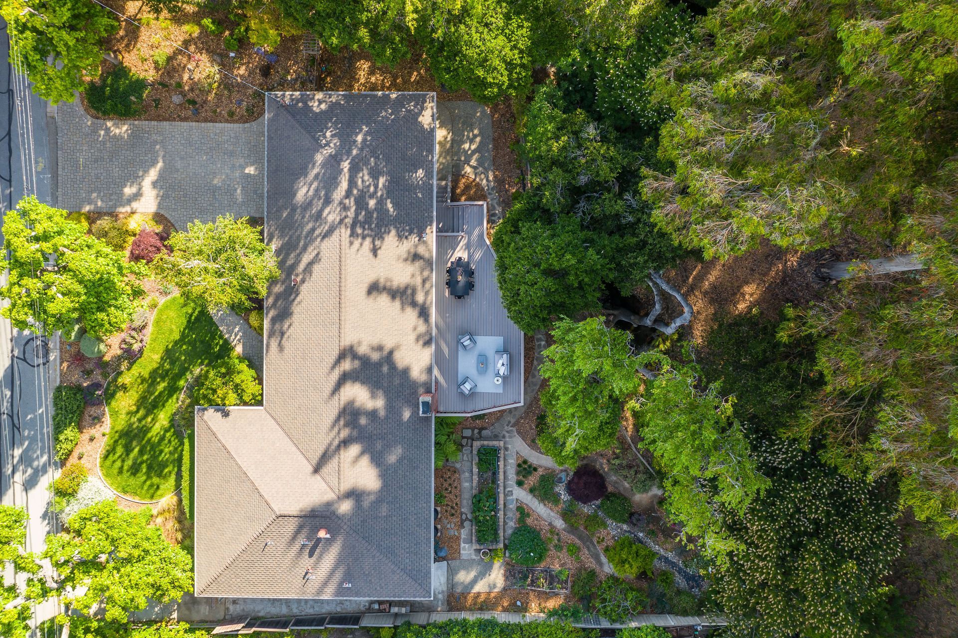 An aerial view of a house surrounded by trees.