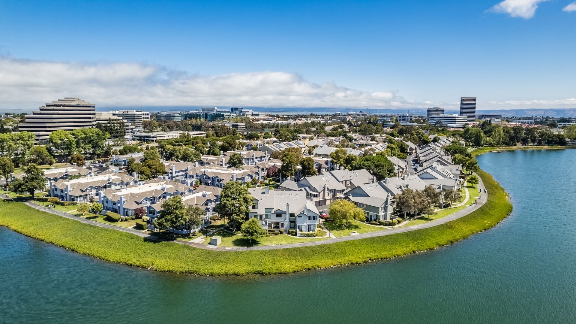 An aerial view of a residential area next to a body of water.