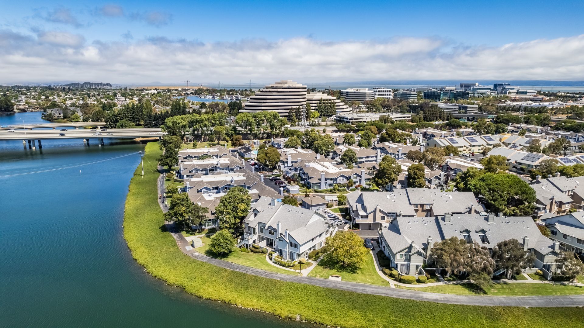 An aerial view of a residential area next to a body of water.
