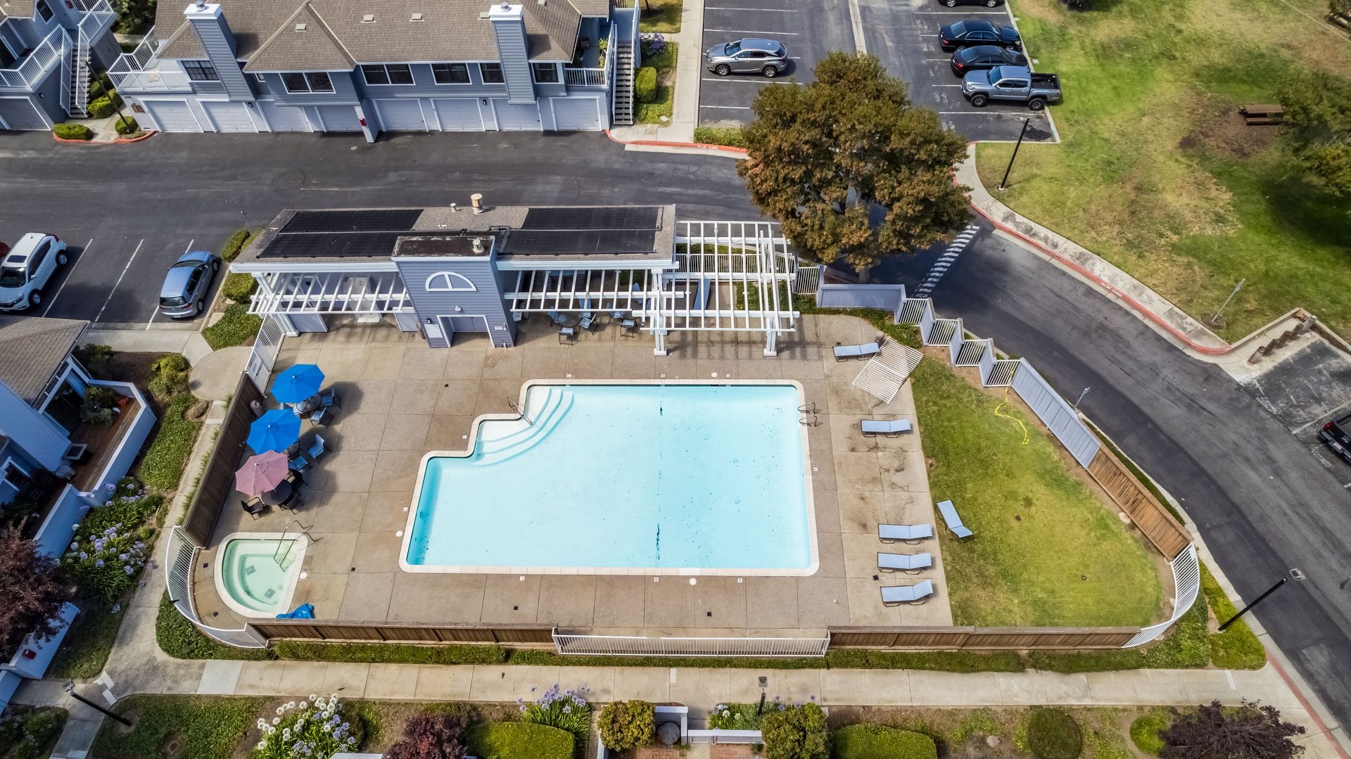 An aerial view of a swimming pool in a residential area.