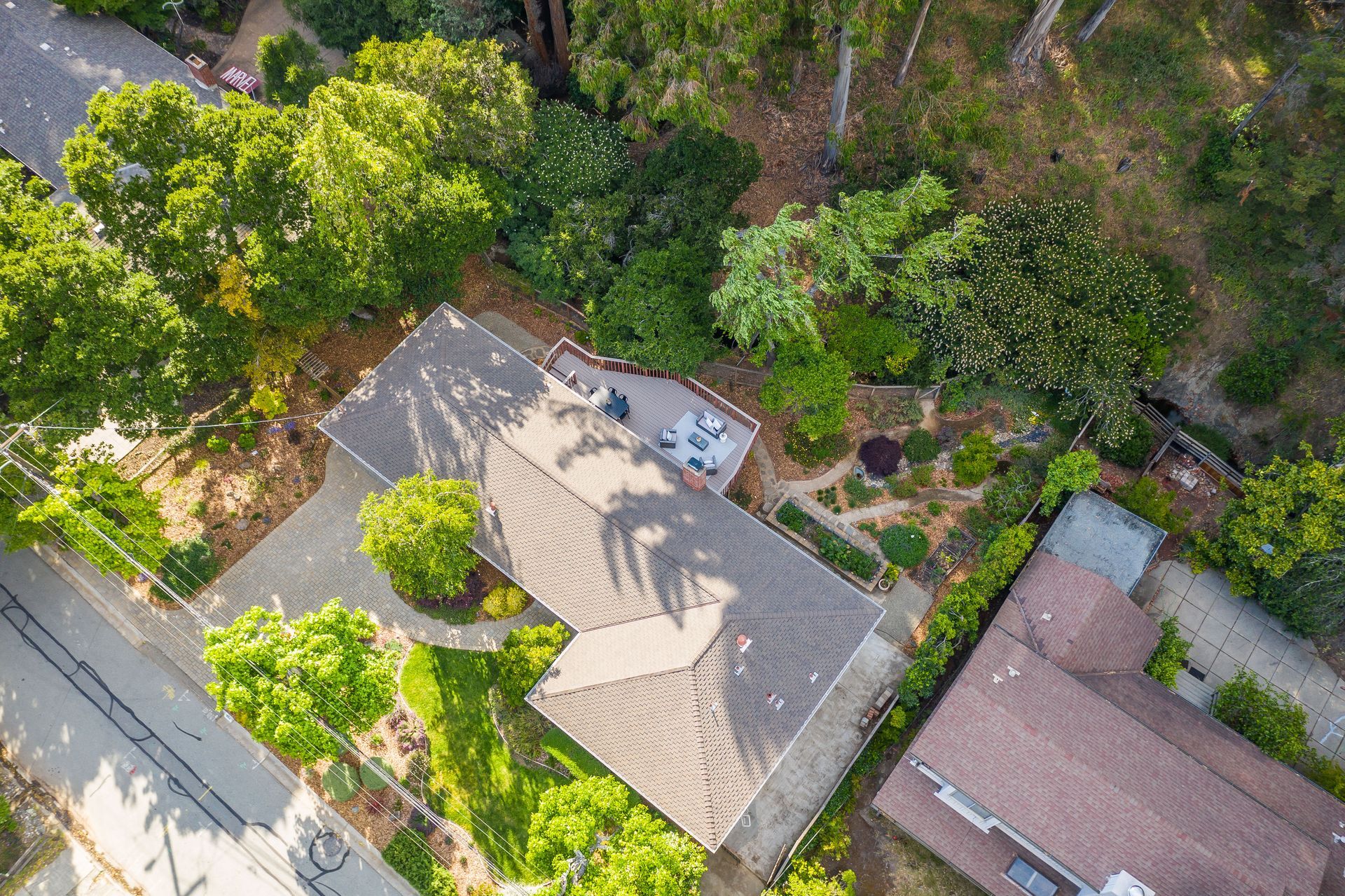 An aerial view of a house surrounded by trees and bushes.