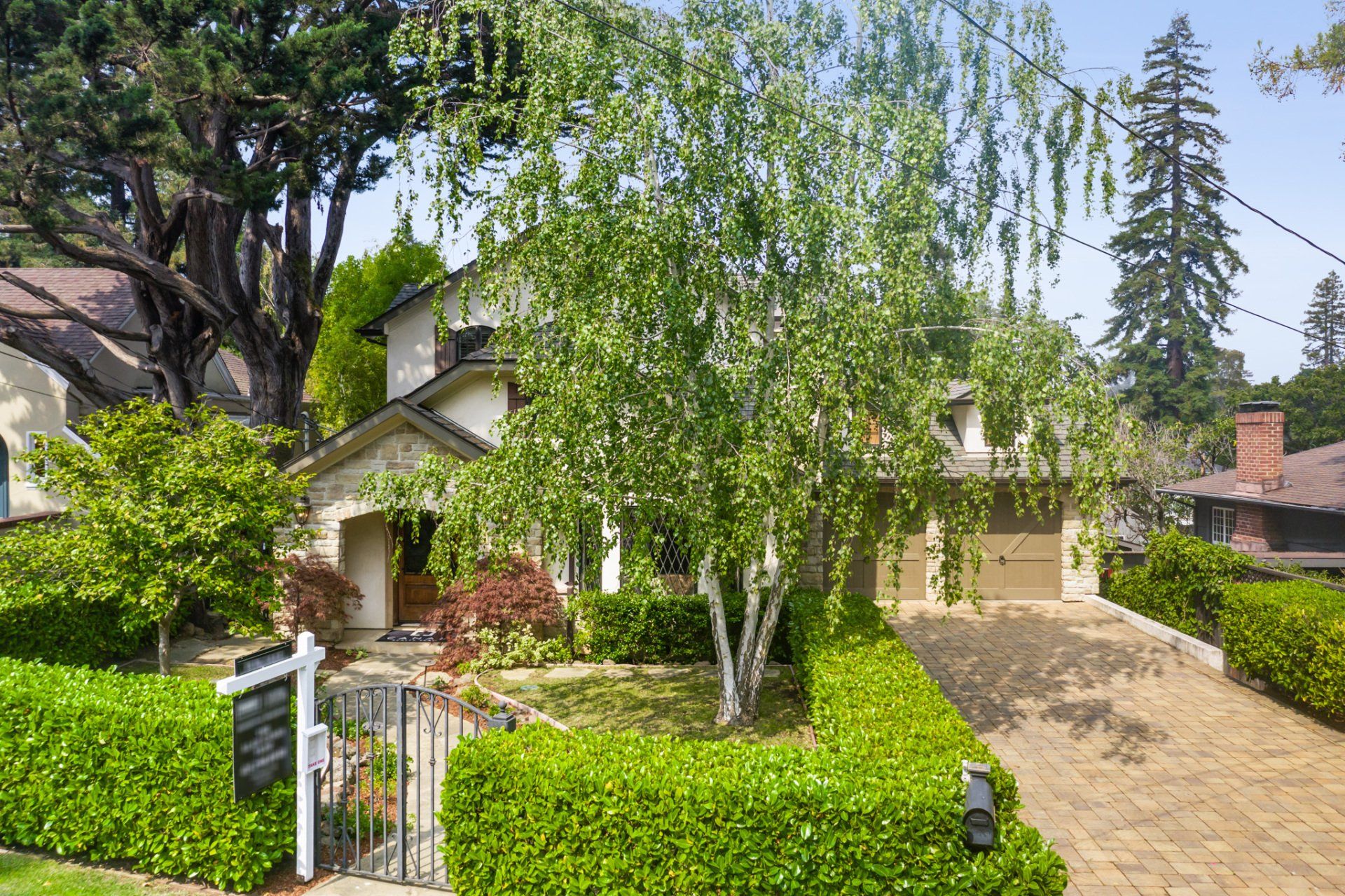 A house with a for sale sign in front of it.