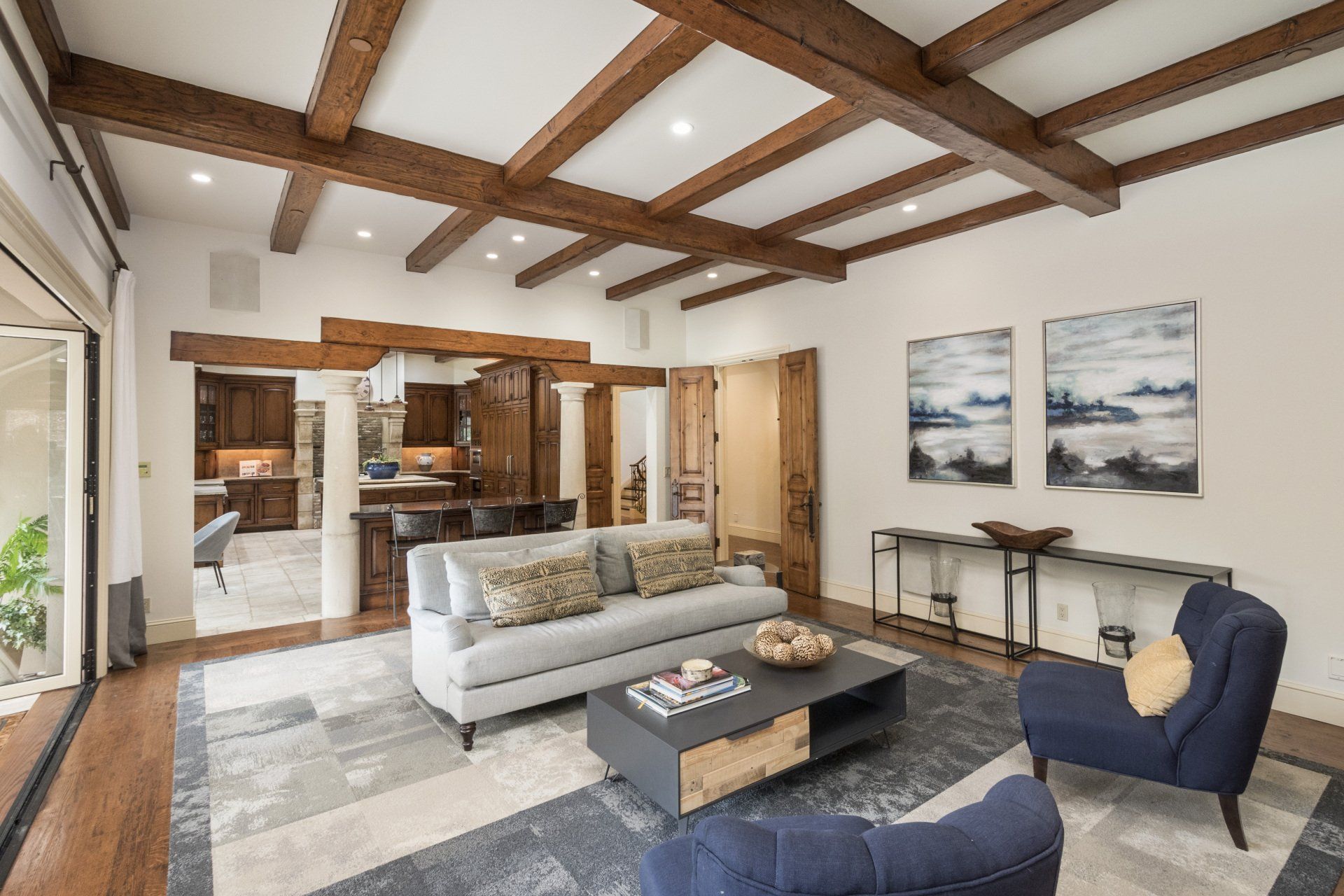 A room with a couch , chairs and a coffee table