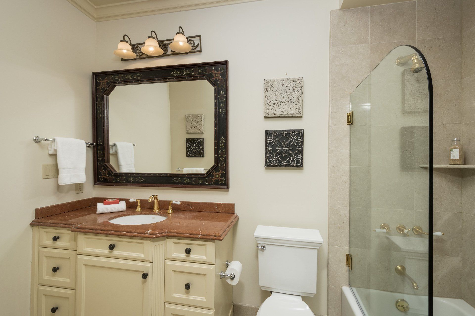 A bathroom with a toilet, a sink and a mirror